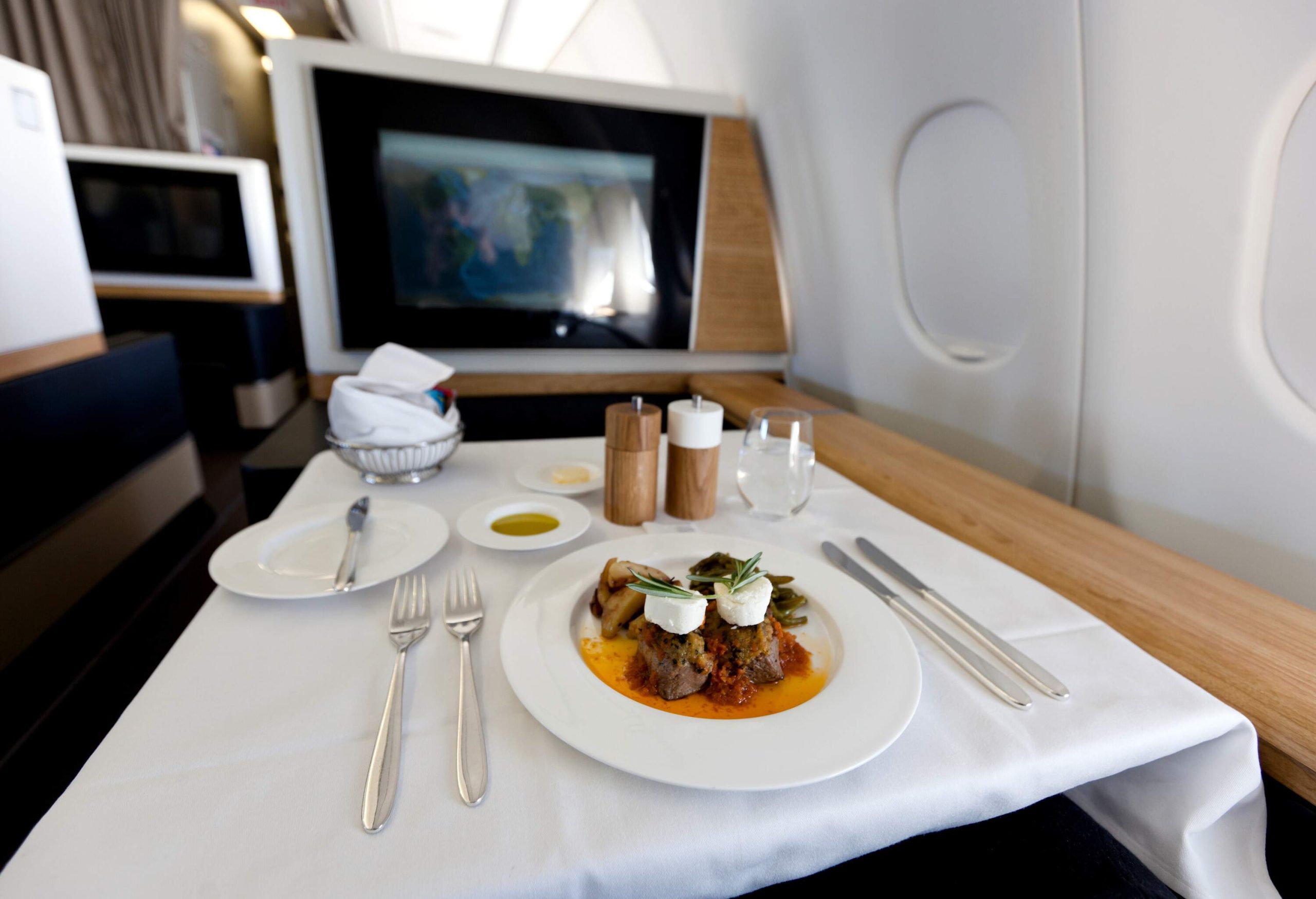 Delectable, first-class cuisine is elegantly presented on a pristine white table.