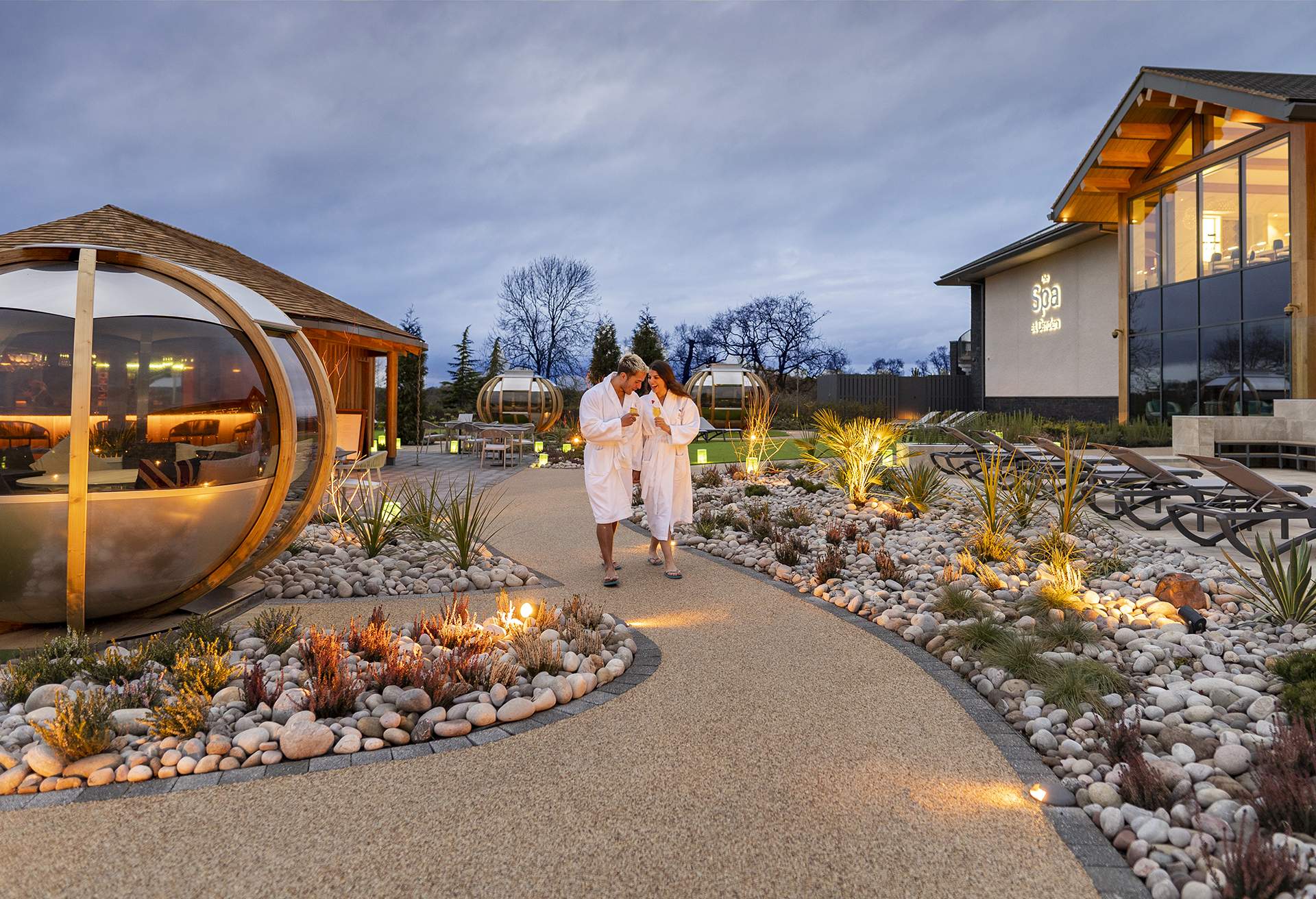 Couple walking outside the Spa at Carden Park Hotel Cheshire, UK