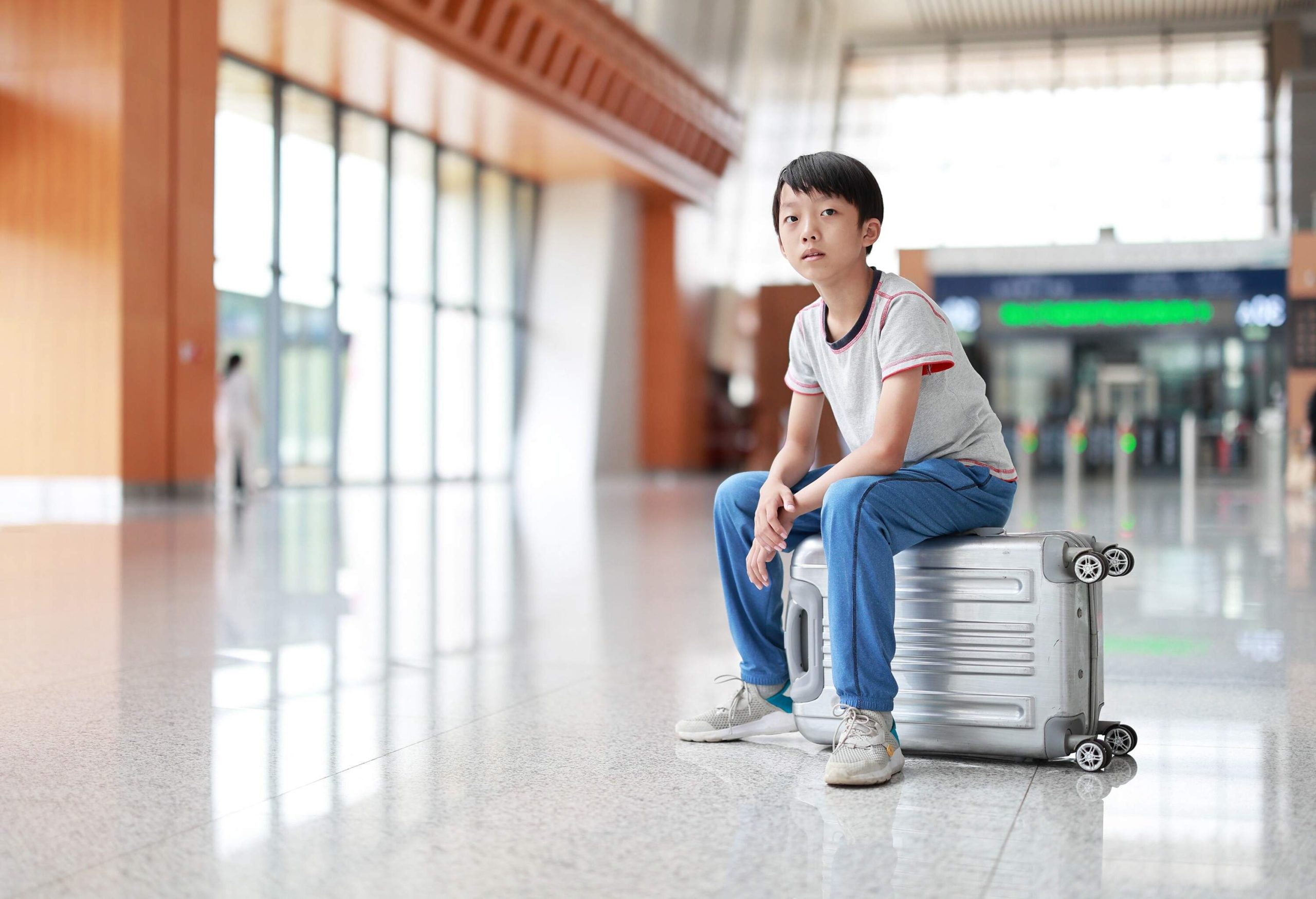 Little boy waiting in the airport, child travel