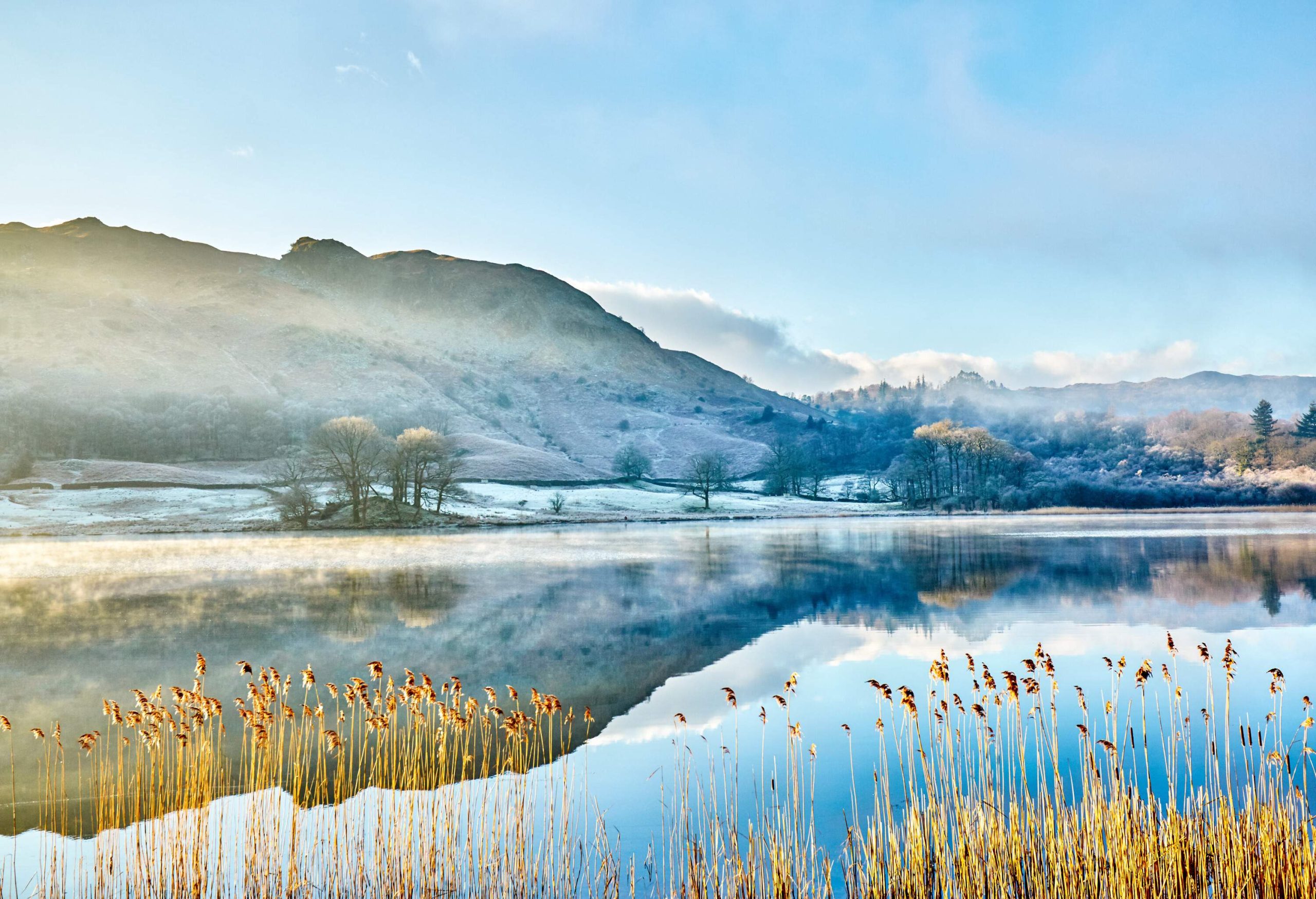 Mist-covered mountains surrounding a frozen lake