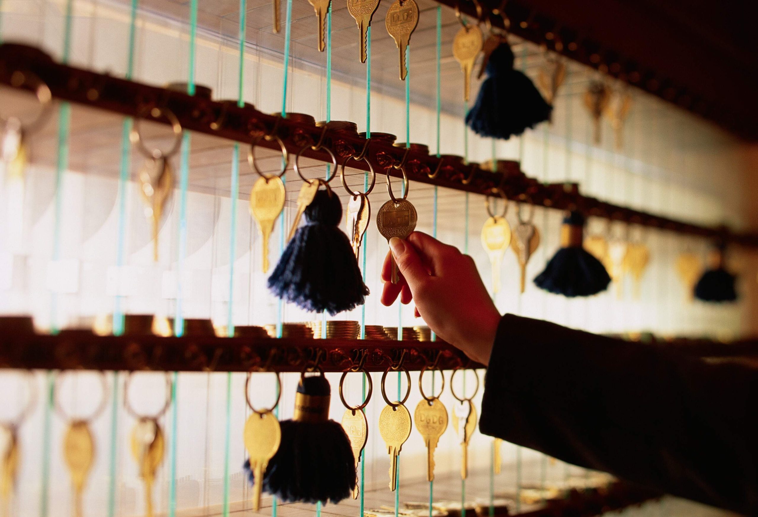 a hand reaching to get a hotel key