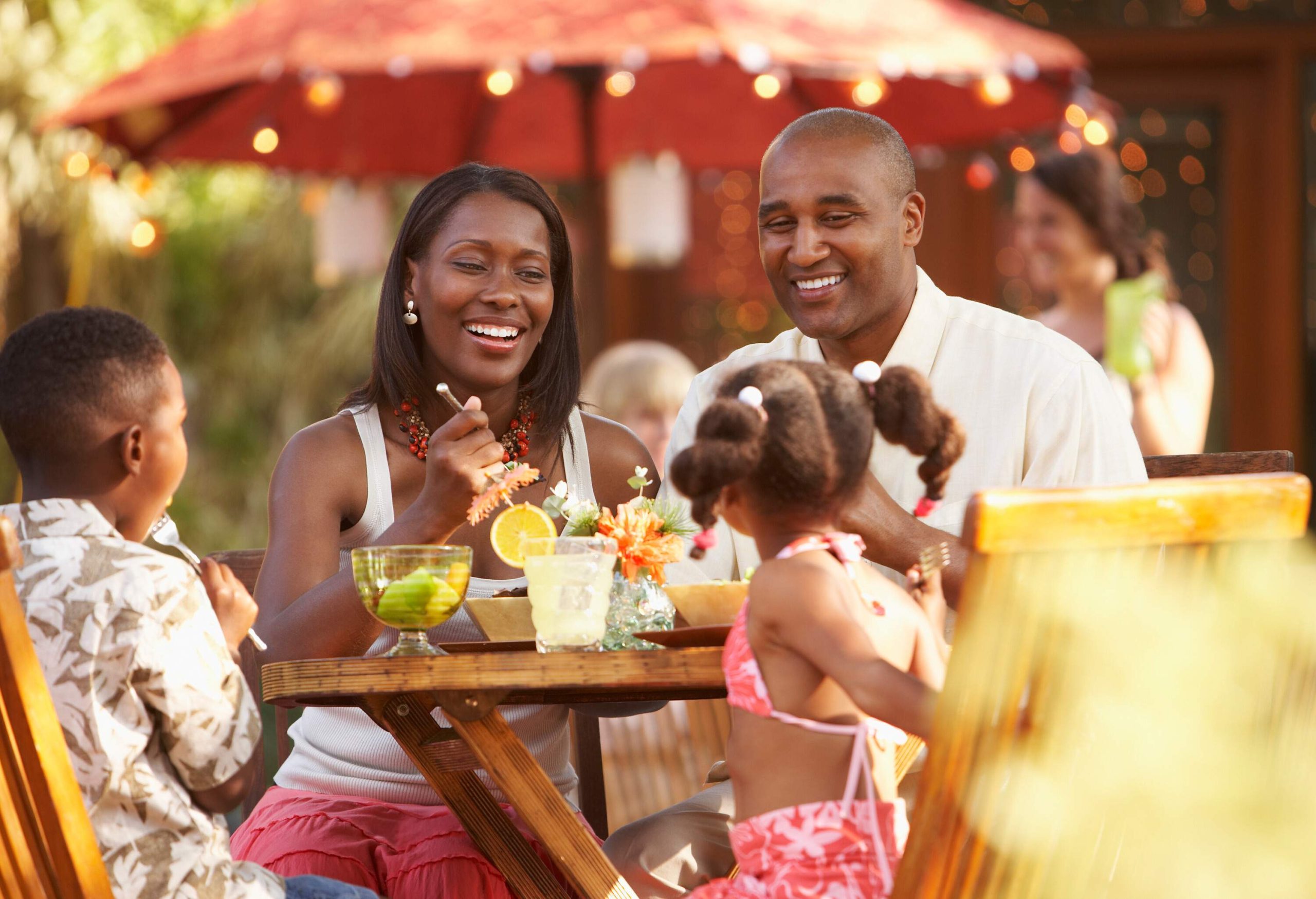 African American family having food at a restaurant at holiday resort