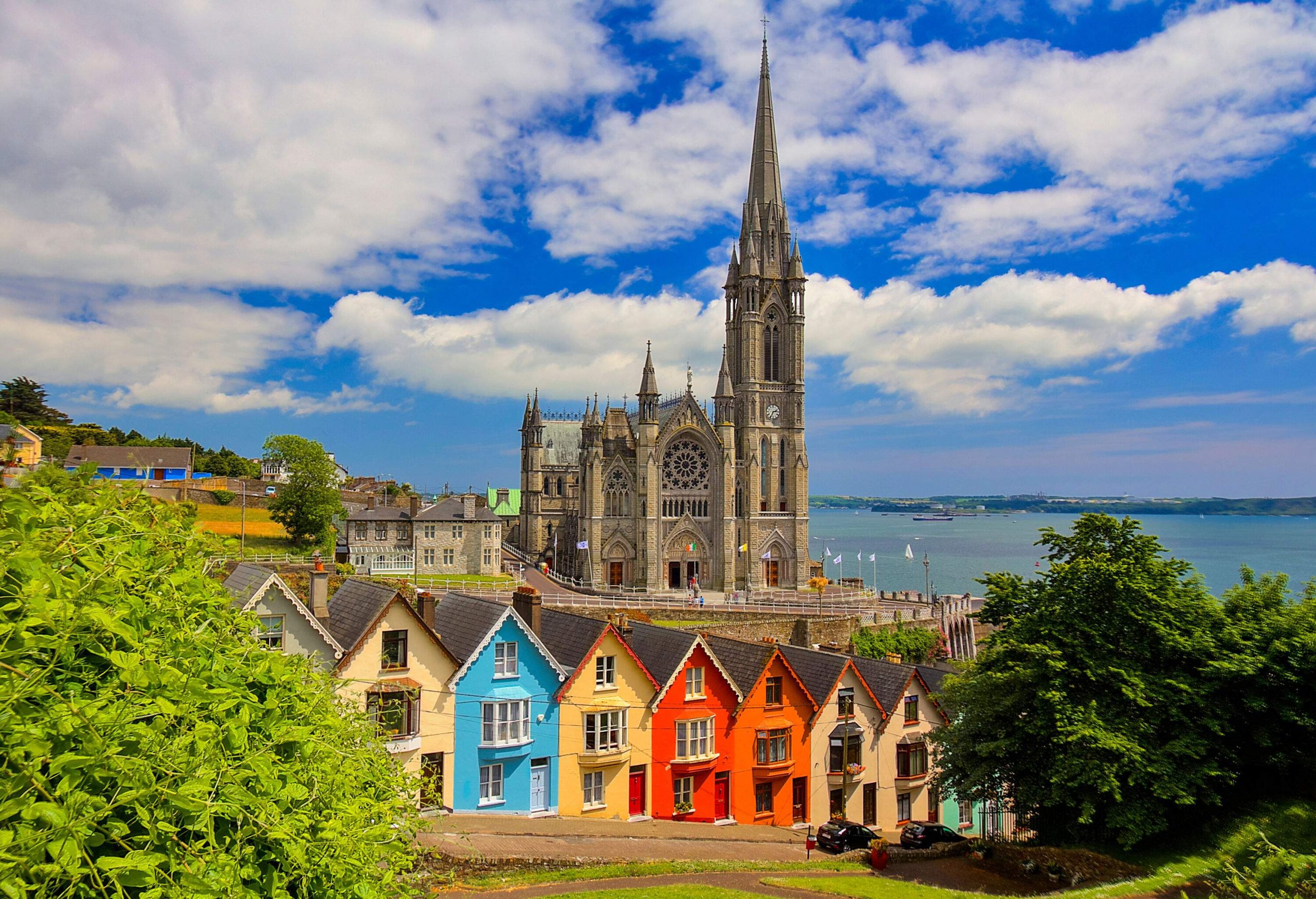 Behind a row of colourful houses layered on a hill is a single-spire cathedral that overlooks the town's natural harbour.