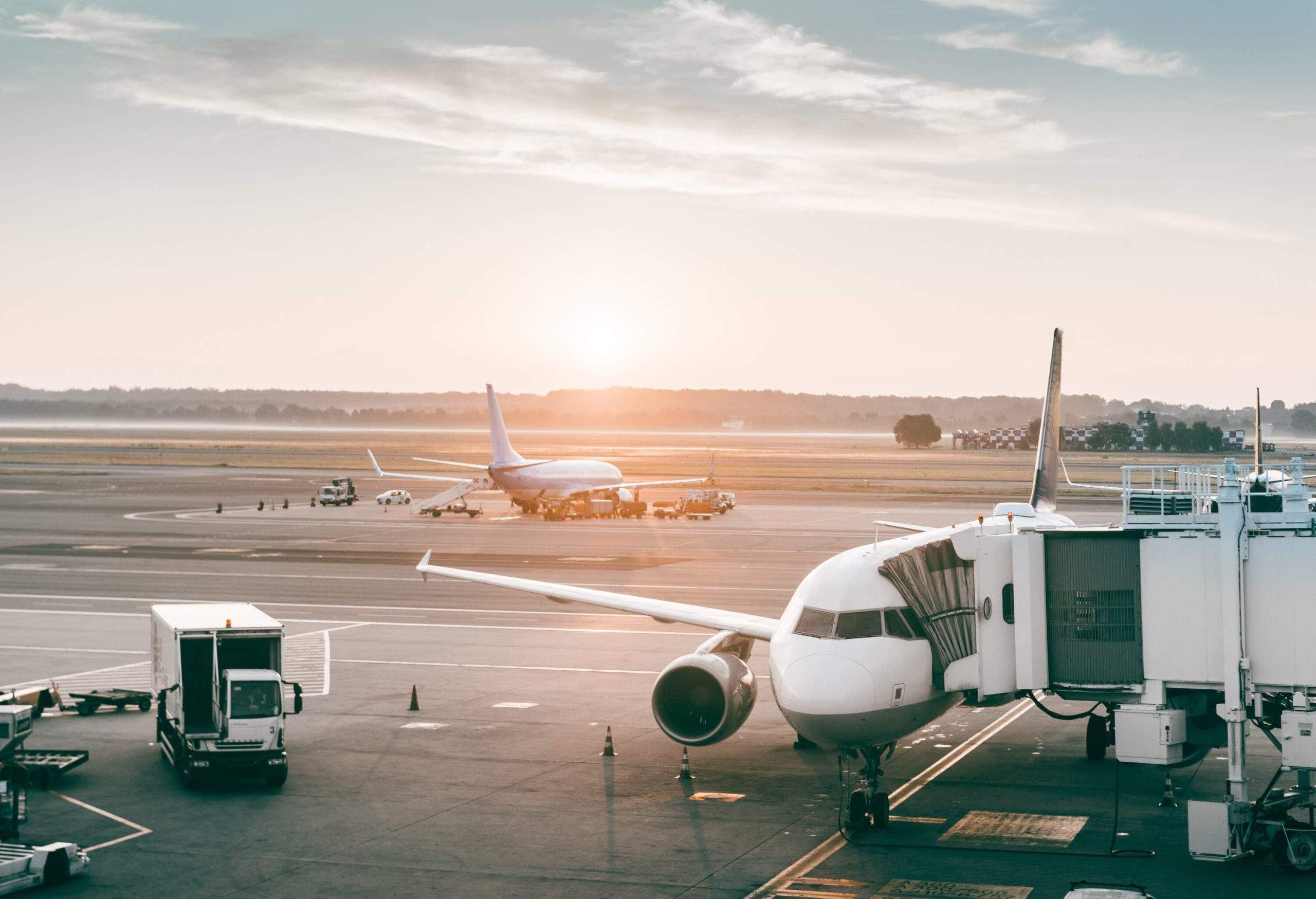 A plane being boarded at the airport on a runway.