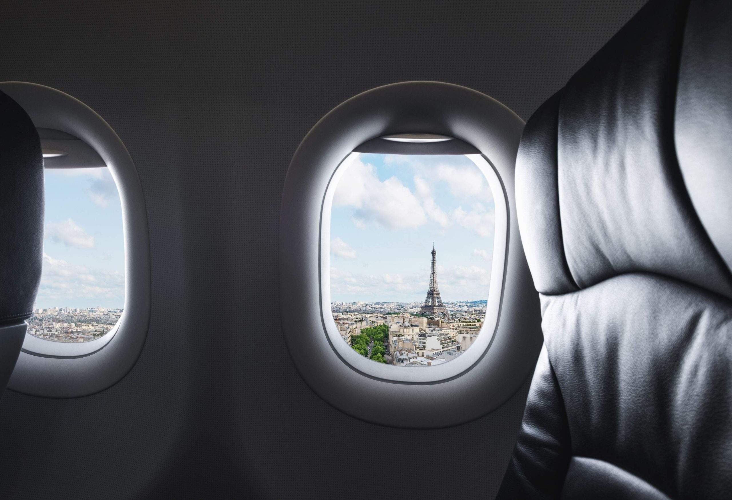 The famous Eiffel Tower is viewed through the window of an airplane.