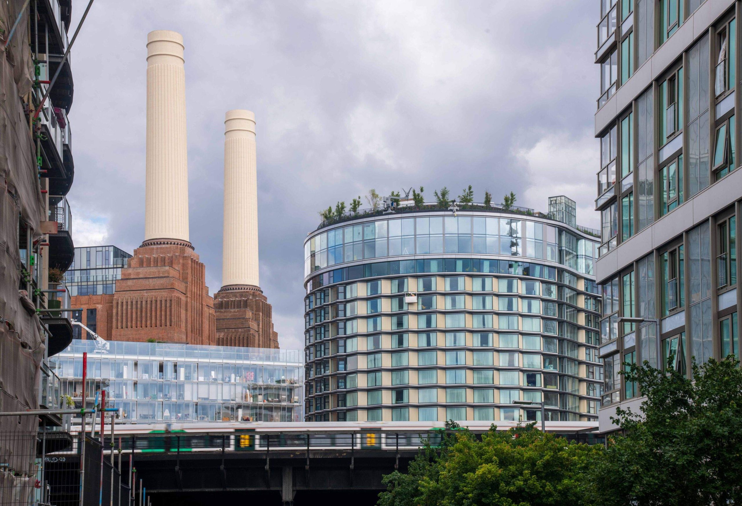 Battersea Power Station with new buildings and train passing