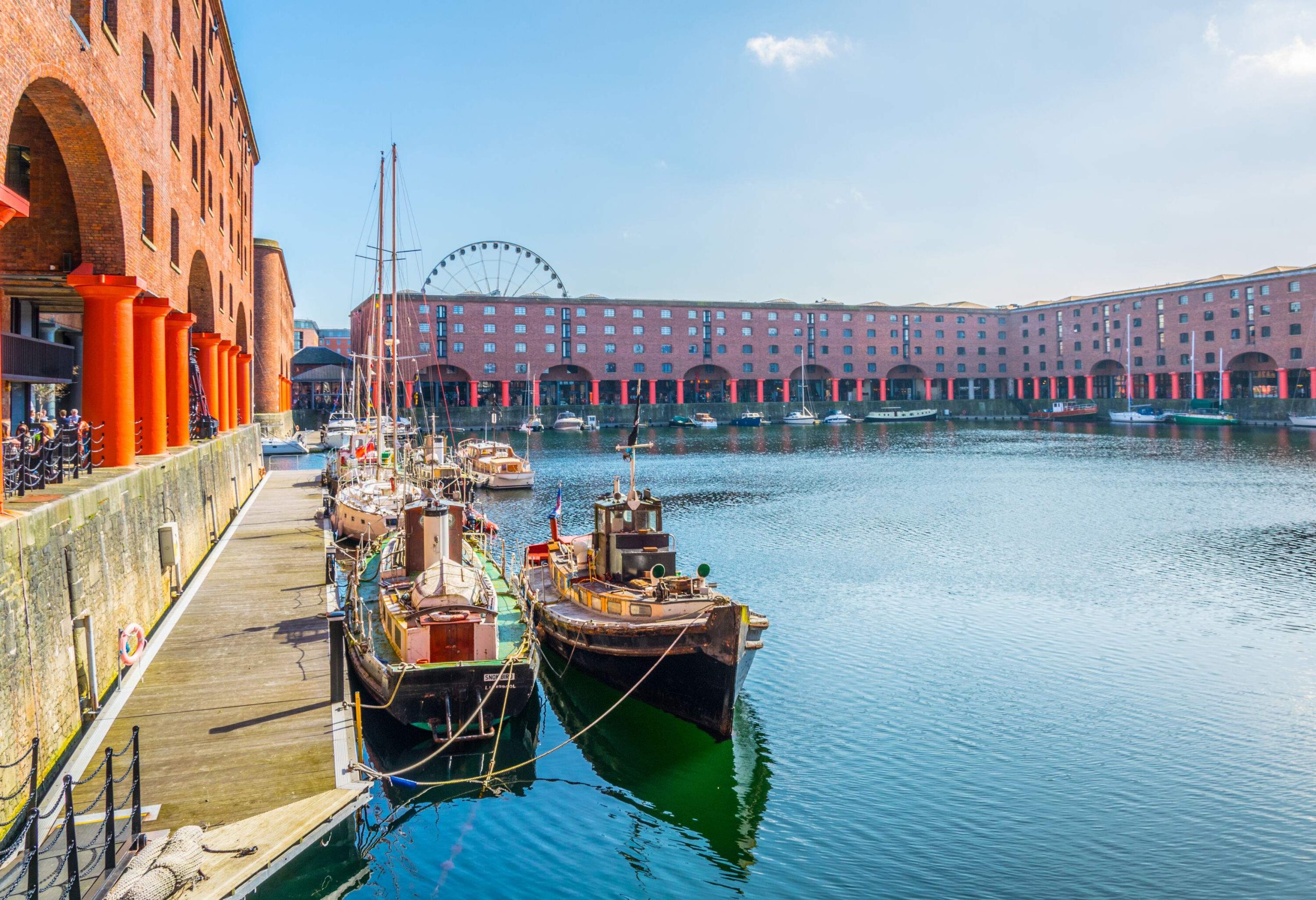 Boats moored in a docking complex surrounded by identical buildings.