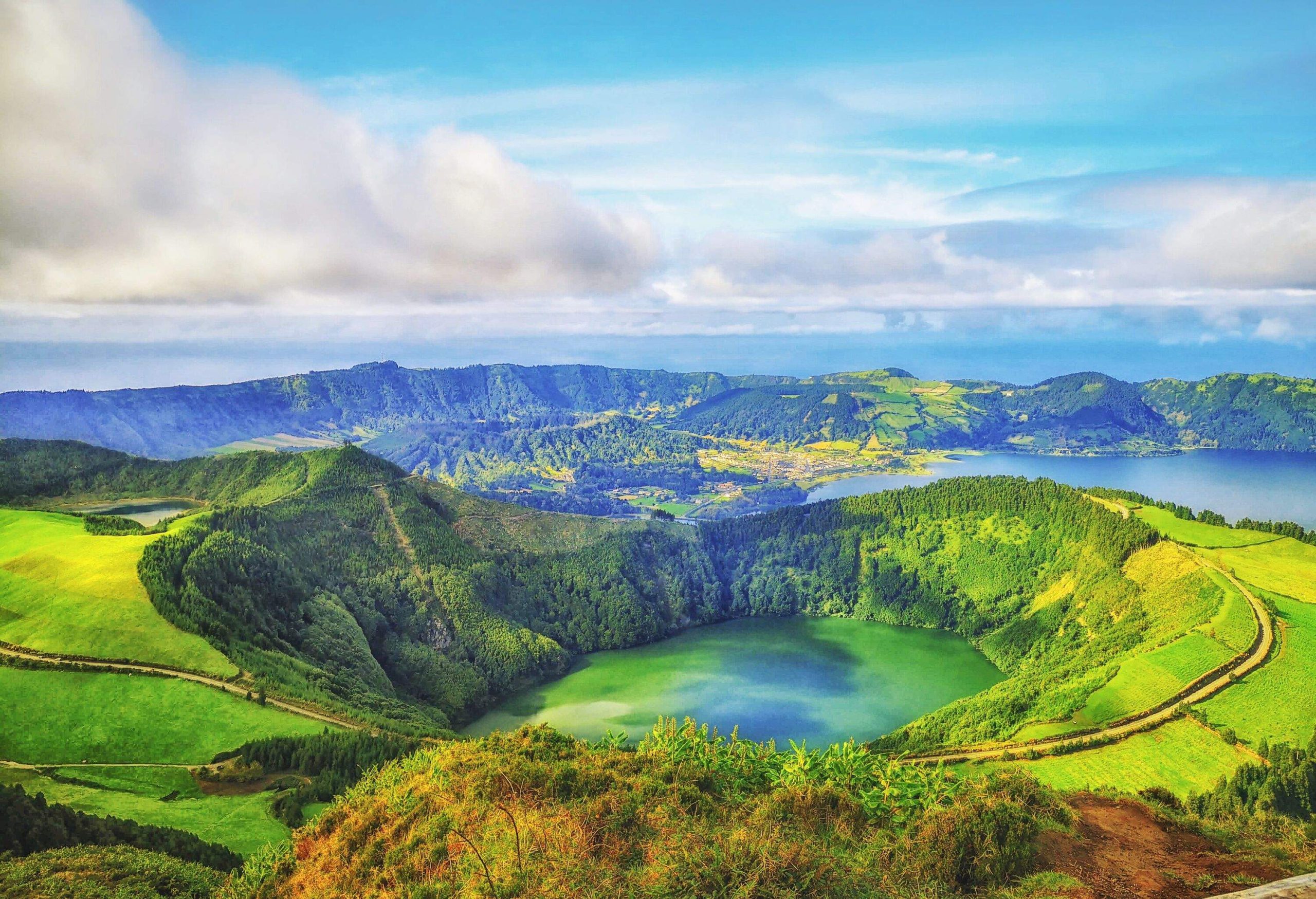 Lagoa das Sete Cidades is a lake in a crater of a dormant volcano surrounded by slopes covered in dense vegetation.