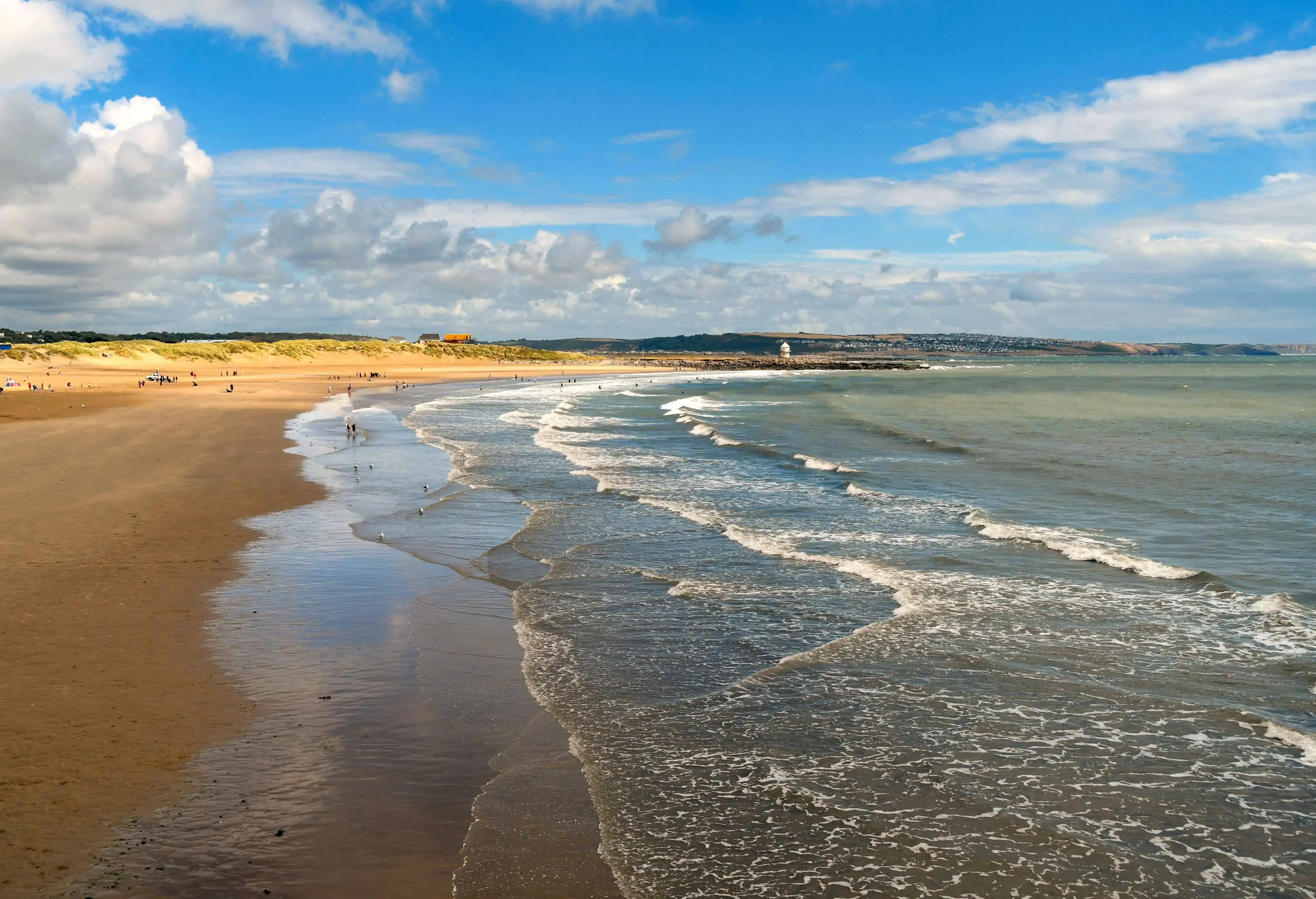 View of Coney Beach in Porthcawl at low tide on a sunny sumer day