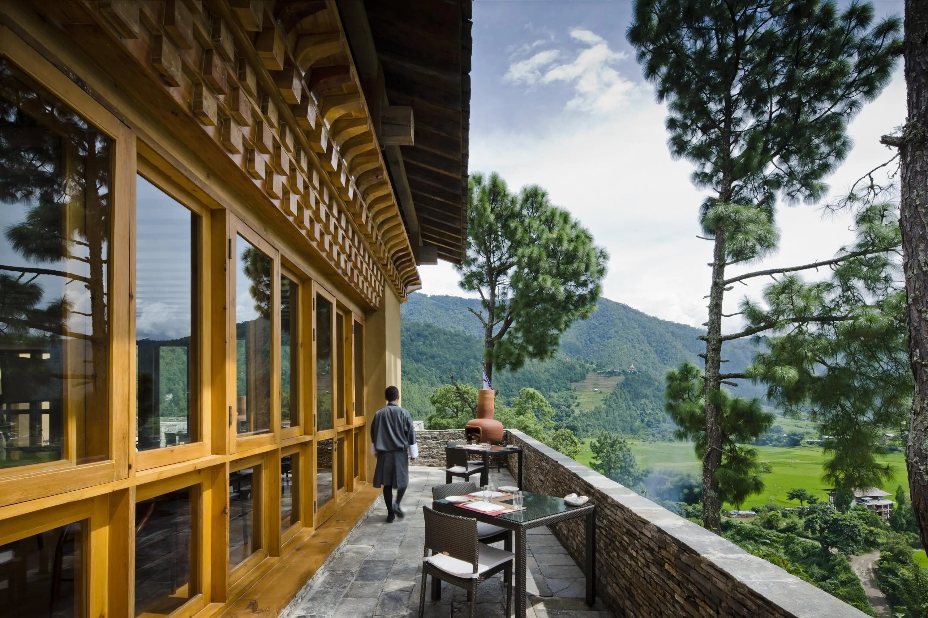 Traditional wooden building structure with balcony overlooking greenery