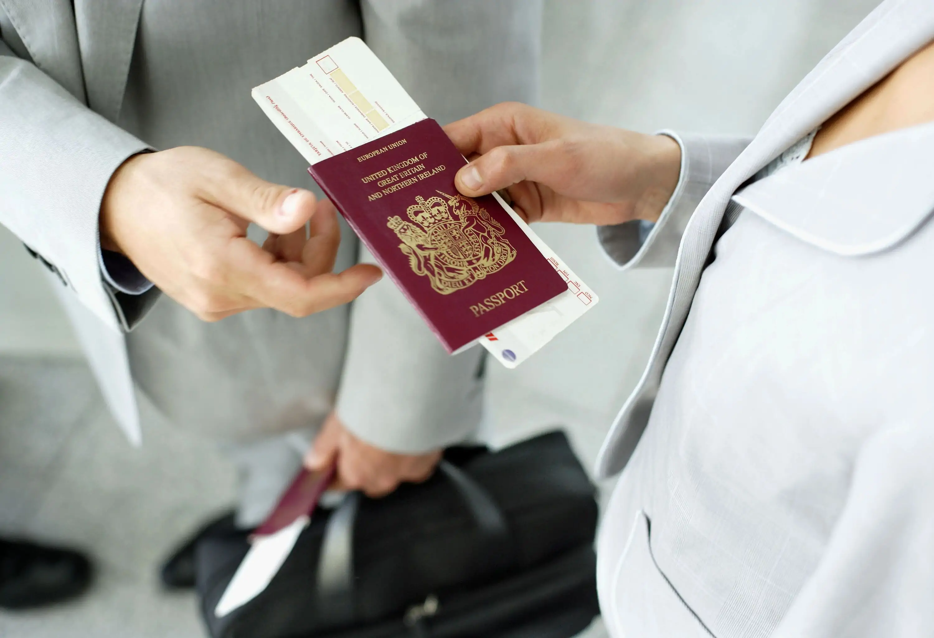 Traveler Handing Passport to Ticket Agent