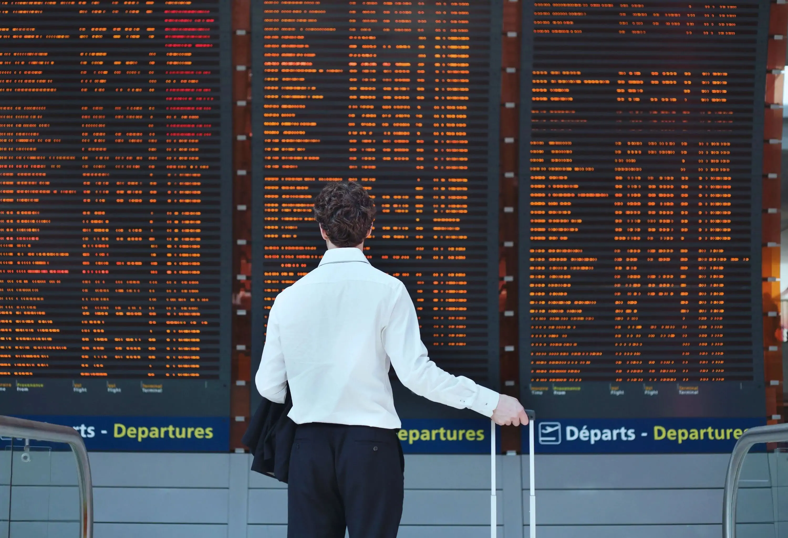 passenger looking at timetable board at the airport