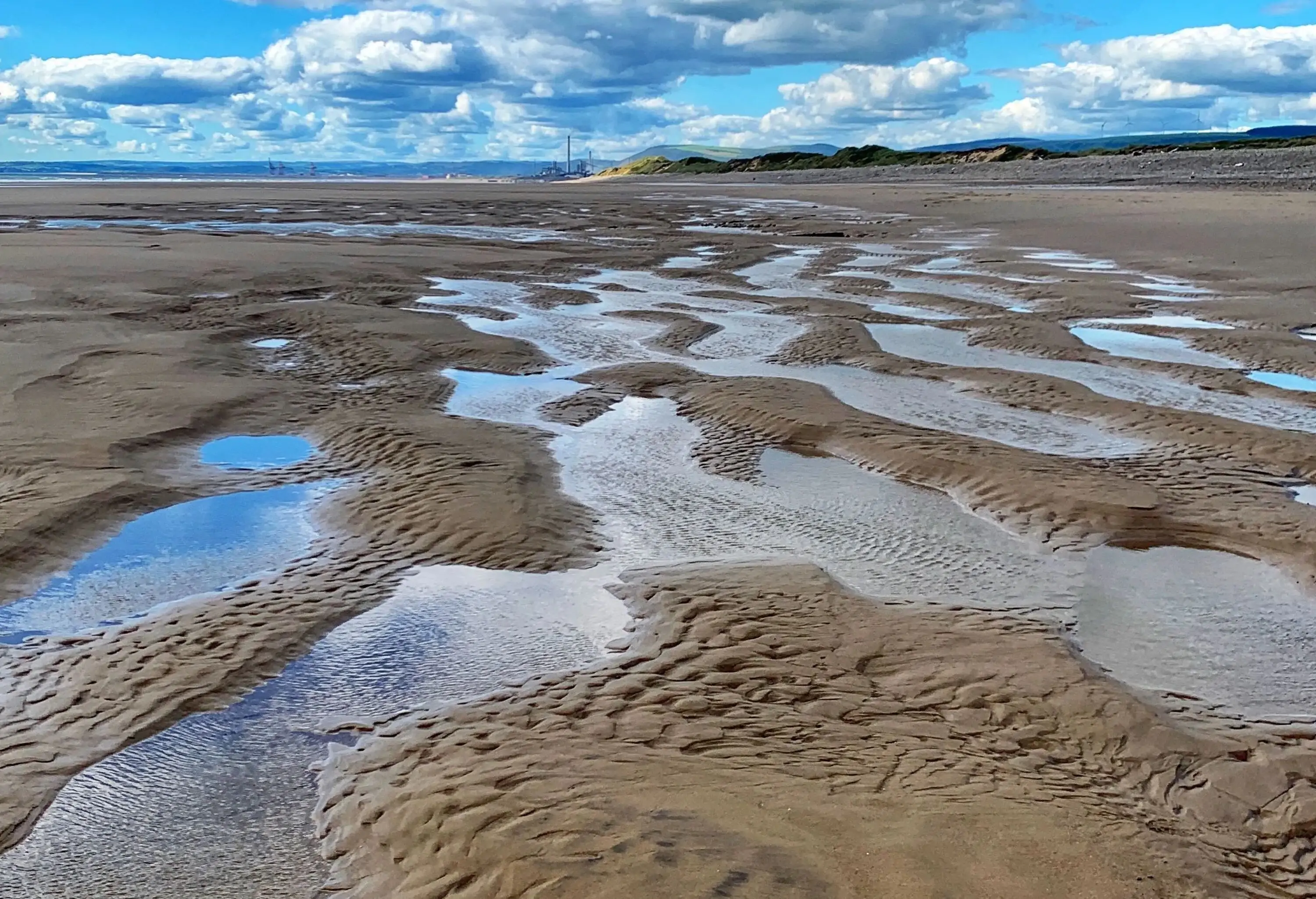 Water pooling on sandy beach
