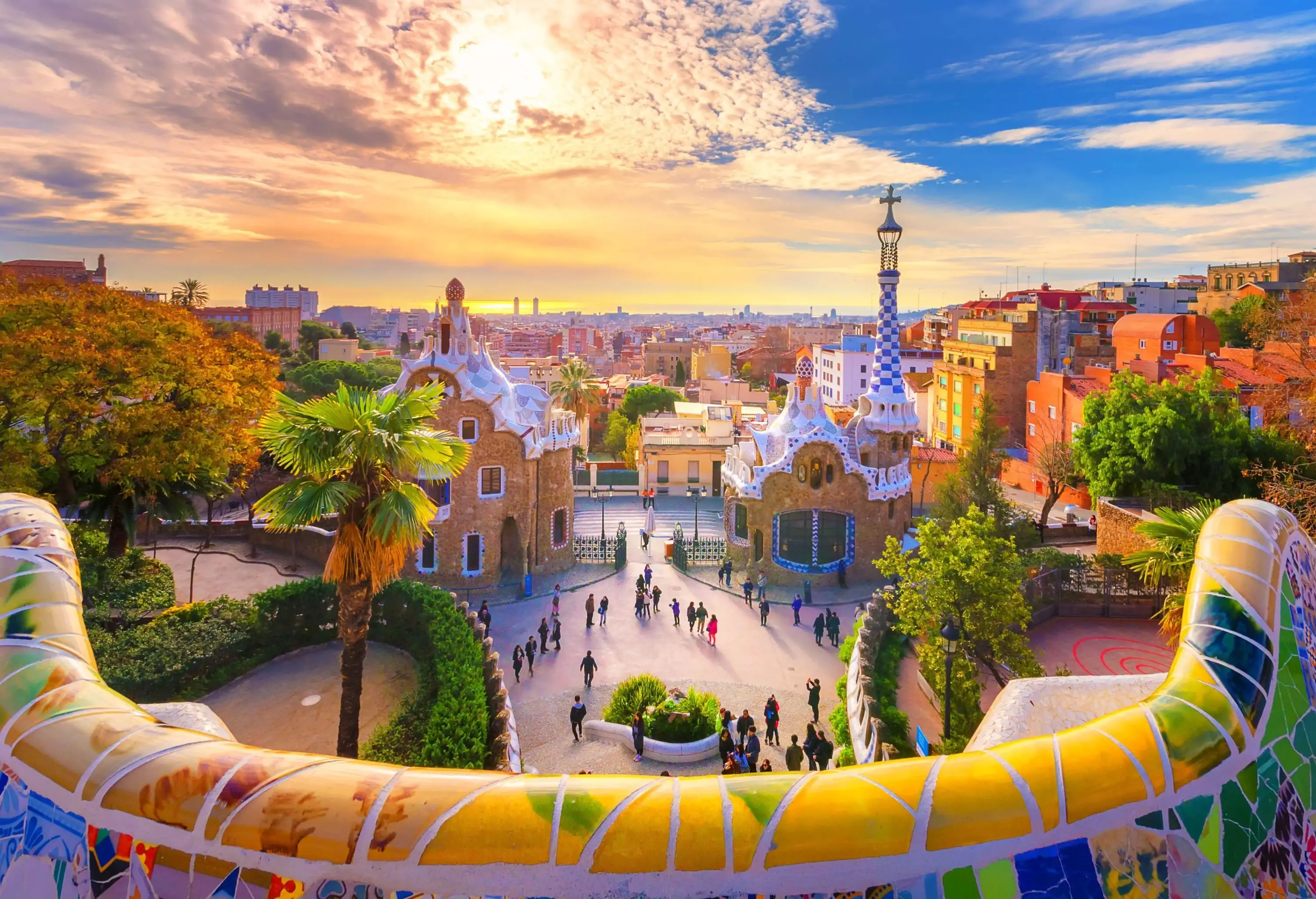 A vibrant park with brilliant mosaics and whimsical buildings.