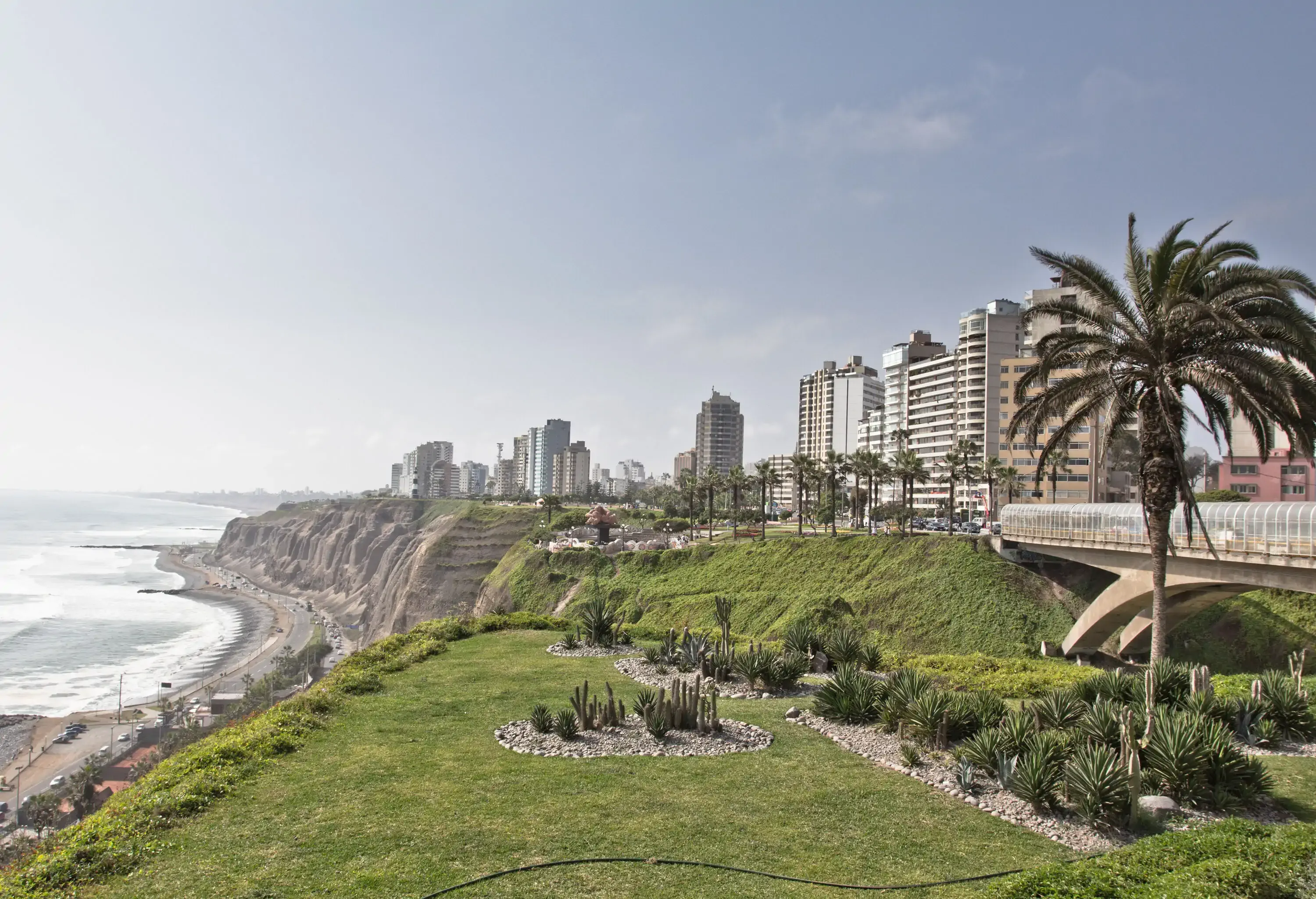 A breathtaking cliff coast with towering buildings overlooks the sea.