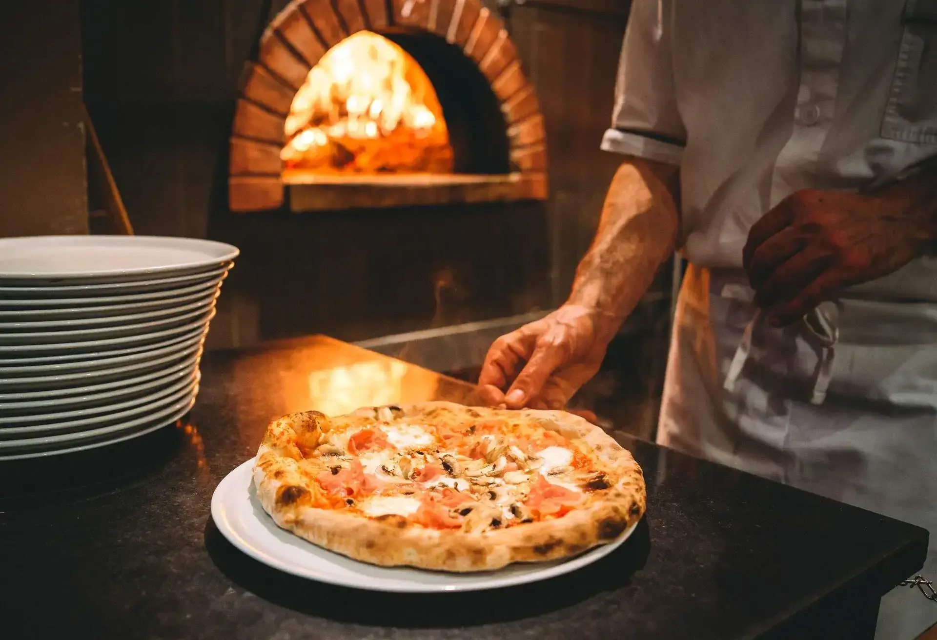 Pizza chef preparing pizza at the restaurant