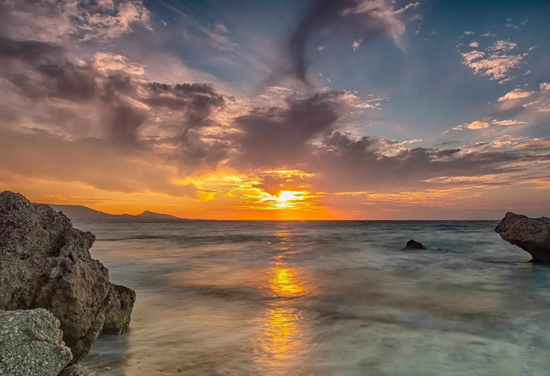 Long exposure photograhy at the rocky Kato Petres Beach landscape at dusk. Rhodes, Greece