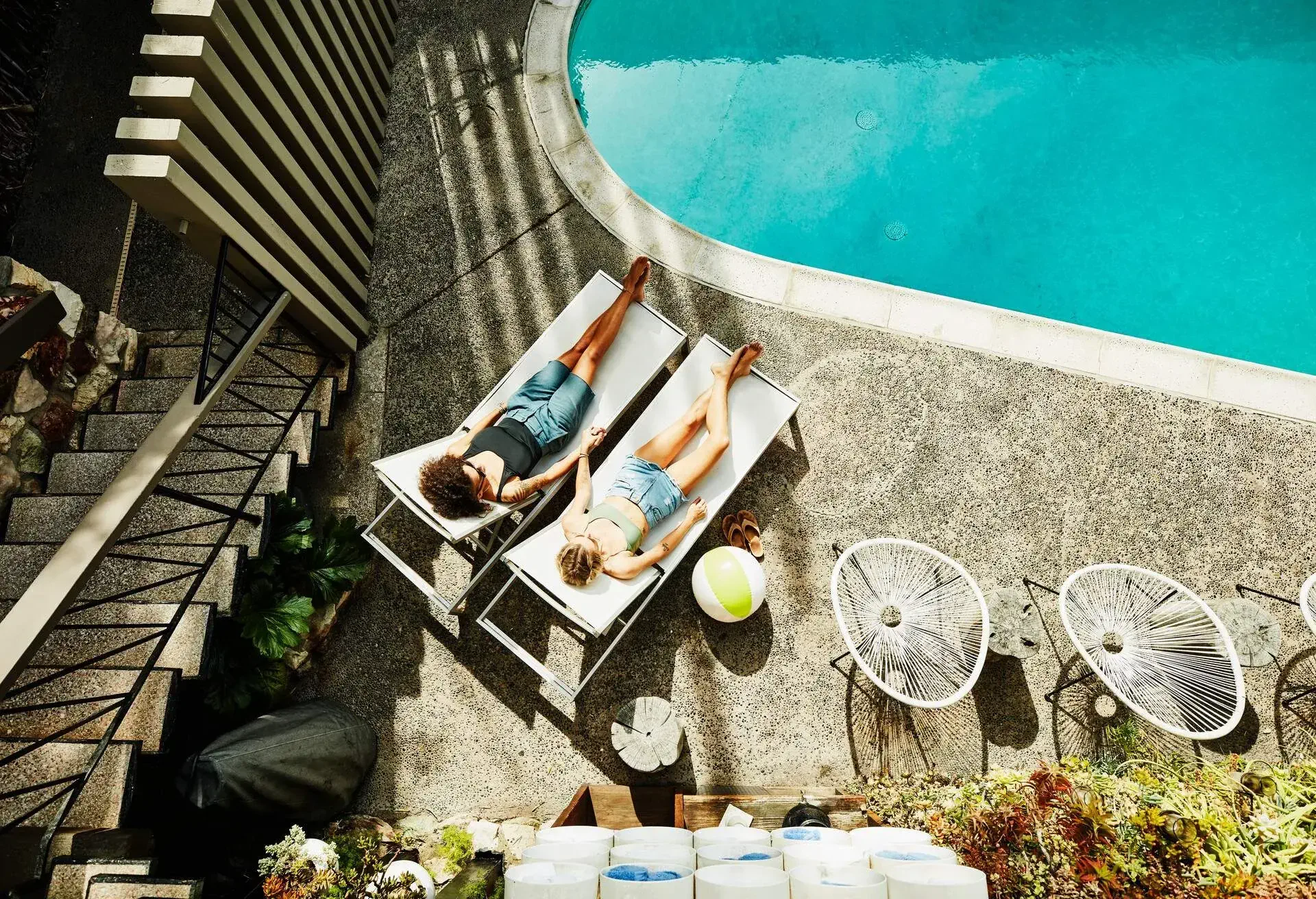THEME_HOTEL_LGBTQ_GAY_COUPLE_POOL_GettyImages-1152878728