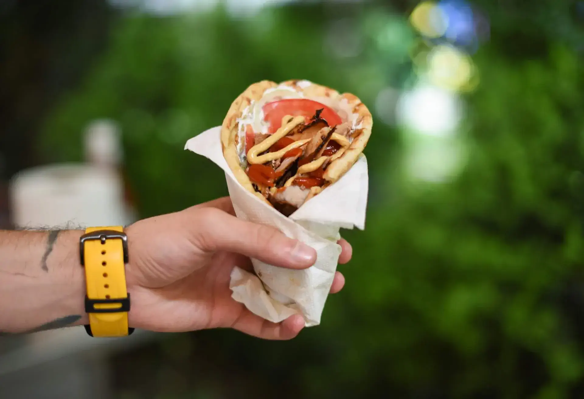 Human hand holding deletions gyro pita