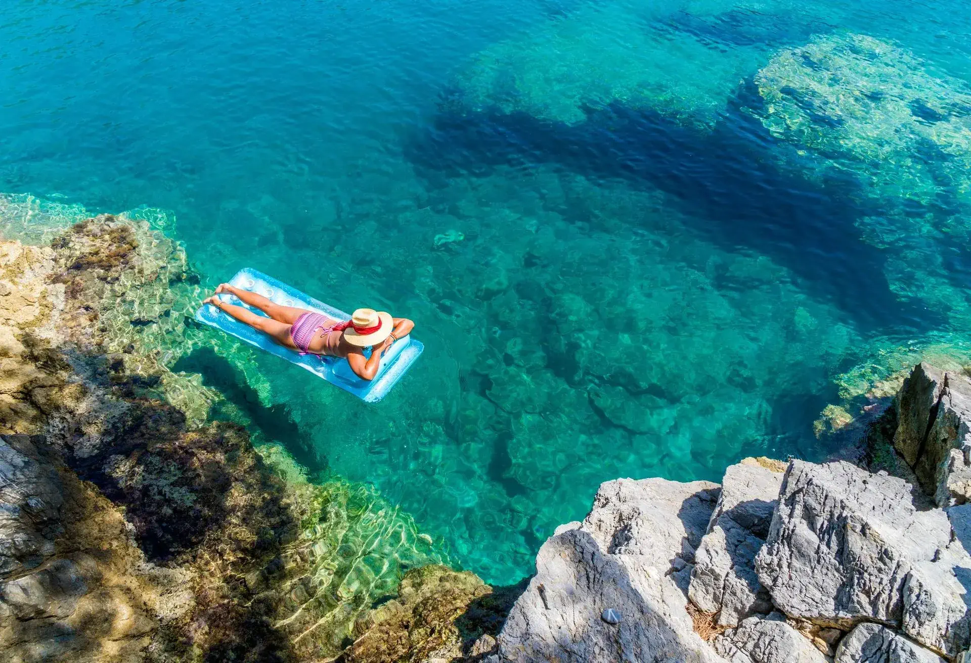 Women is sunbathing on the seabed.