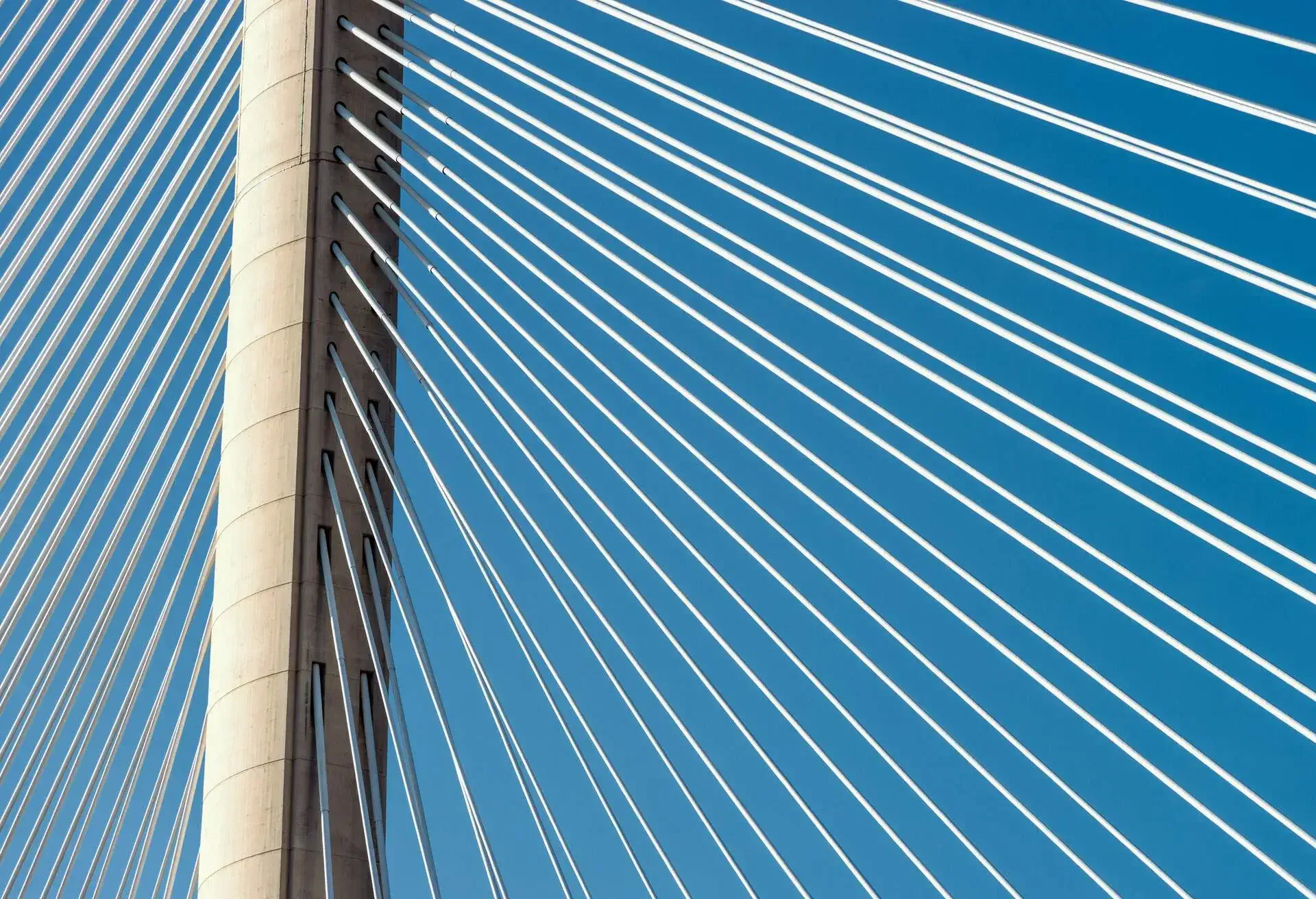 A close-up of one of the Queensferry Crossing bridge's three concrete towers, with steel cables radiating from the tower.