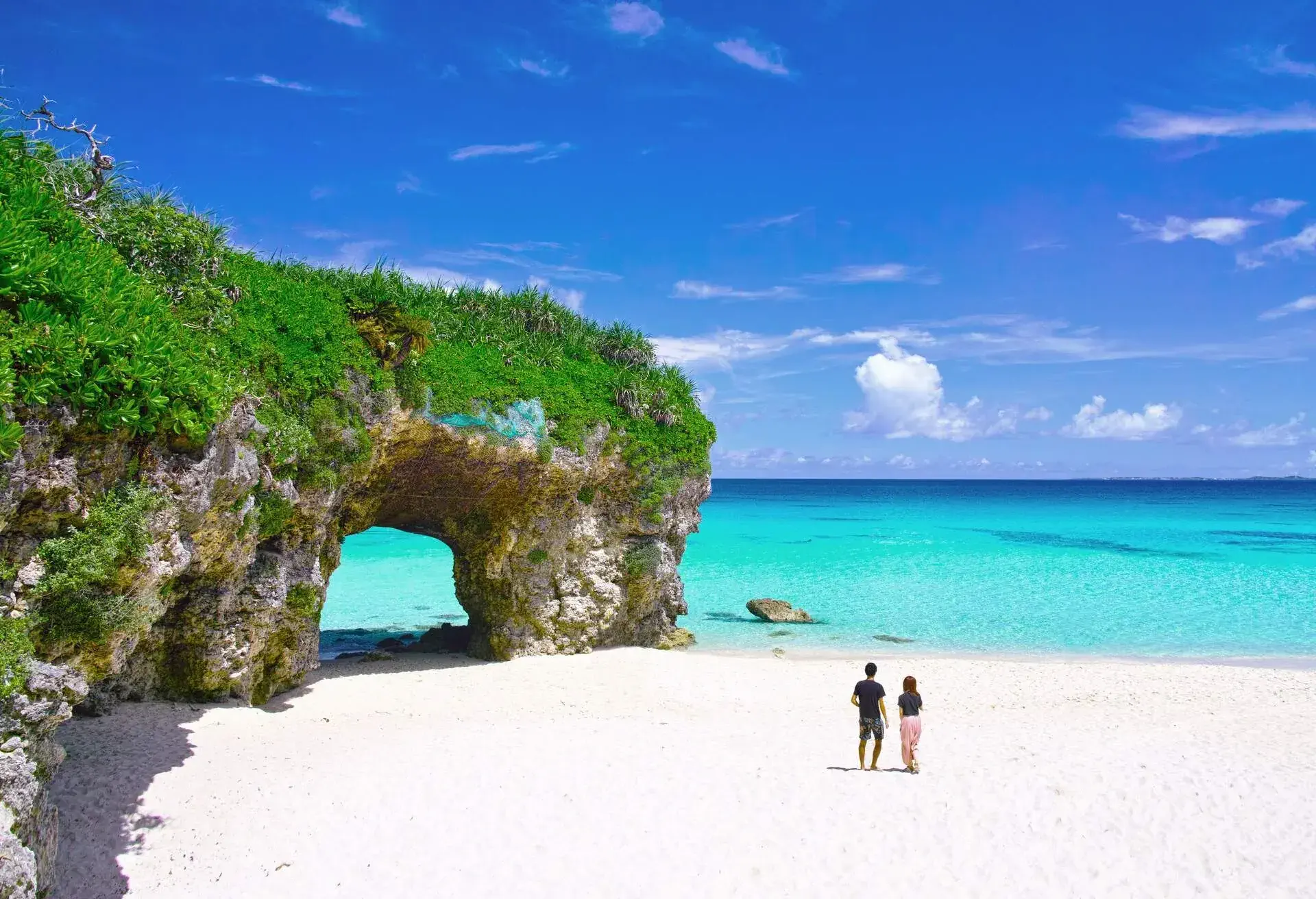 Miyakojima in summer. A couple watching the ocean at Sunayama beach; Shutterstock ID 1071224255
