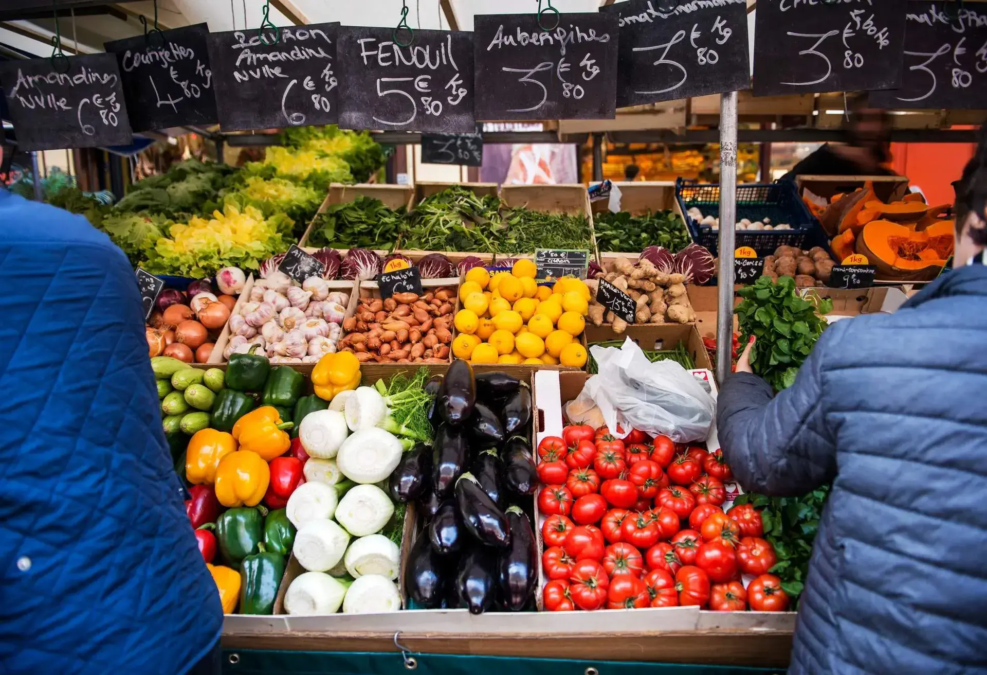 Busy and lively street market during the weekend at Place d'Algre in front of The Beauvau covered market. The market offer local fresh vegetable, spices, cheese. Paris France