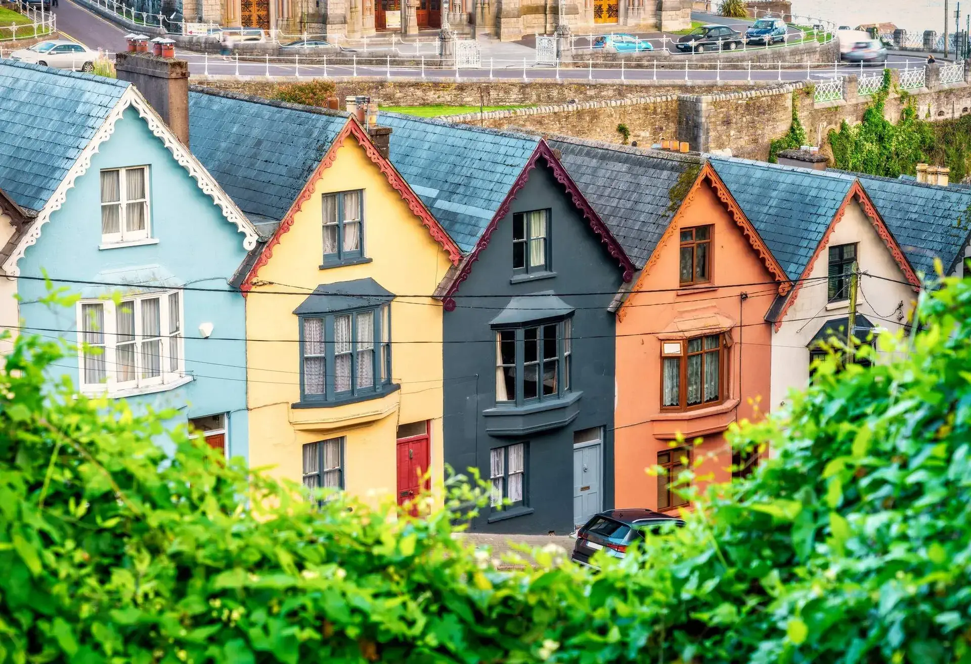 Cobh is a harbor town in County Cork, Ireland and was formerly known as Queenstown. It remains one of the major Irish ports. These houses are very colourful – the so-called 'Deck of Cards' houses, 23 equal houses built on 23 levels and each one differs in color from the other. Cobh, County Cori, Republic of Ireland, Europe.