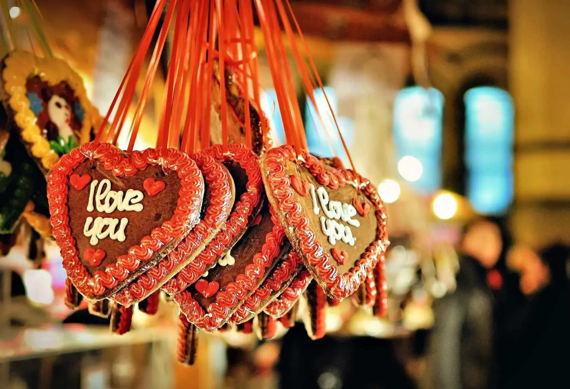 Decorated gingerbread hearts on a Christmas market stall.
