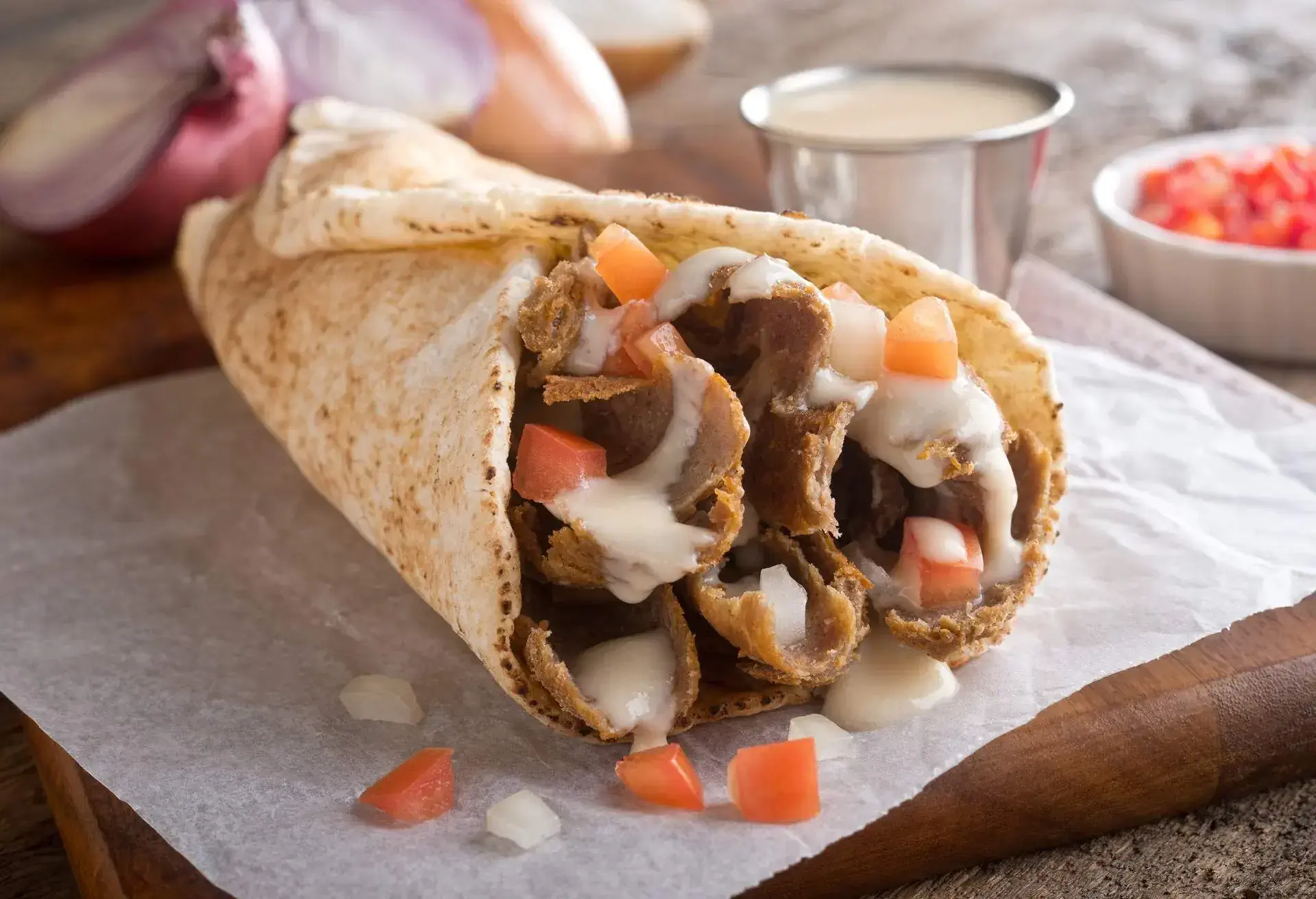 A delicious, authentic east coast take out donair with tomato, onion and sauce.