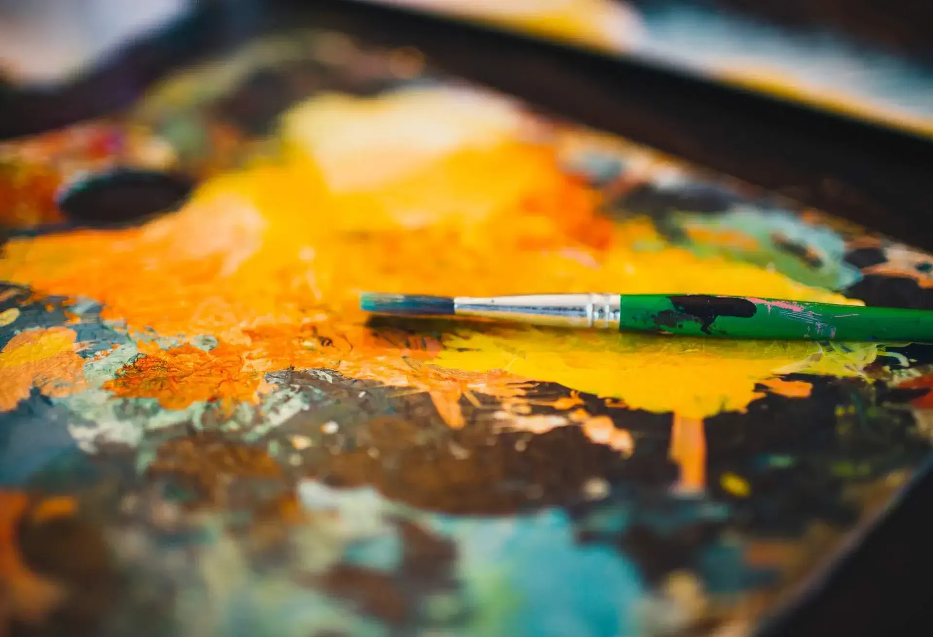 Paint brush placed on dried paint