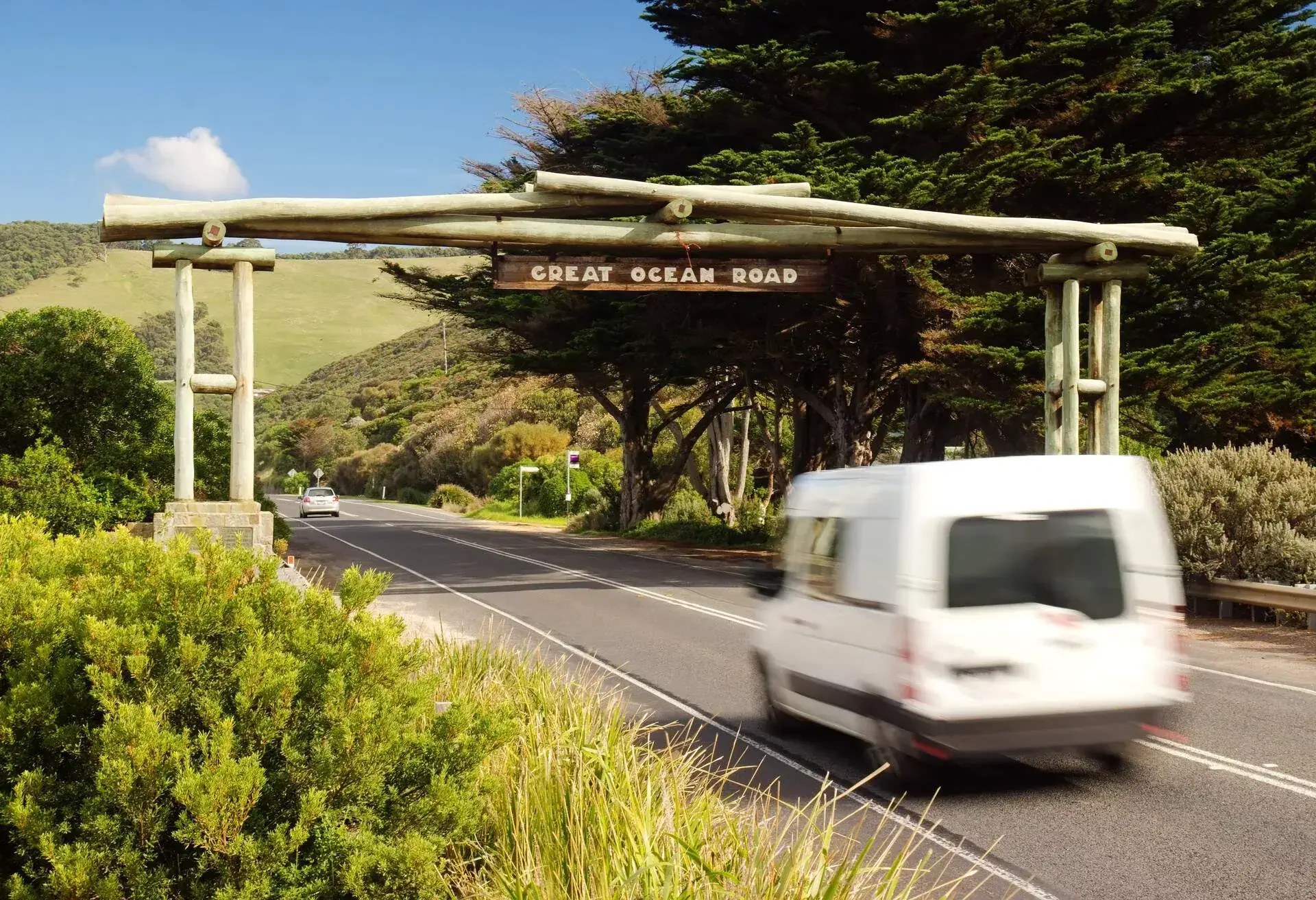 A campervan passes beneath the memorial arch on the Great Ocean Road in Victoria. The scenic road winds down the coast of Victoria and is popular with tourists.