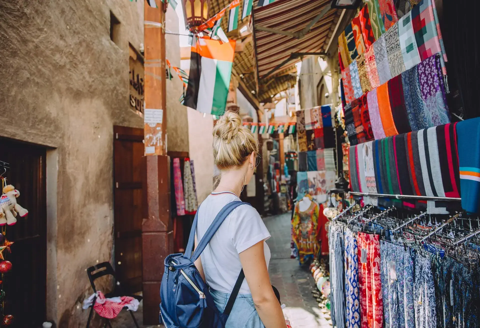 Back view of young female traveller at traditional bazaar in Dubai, UAE