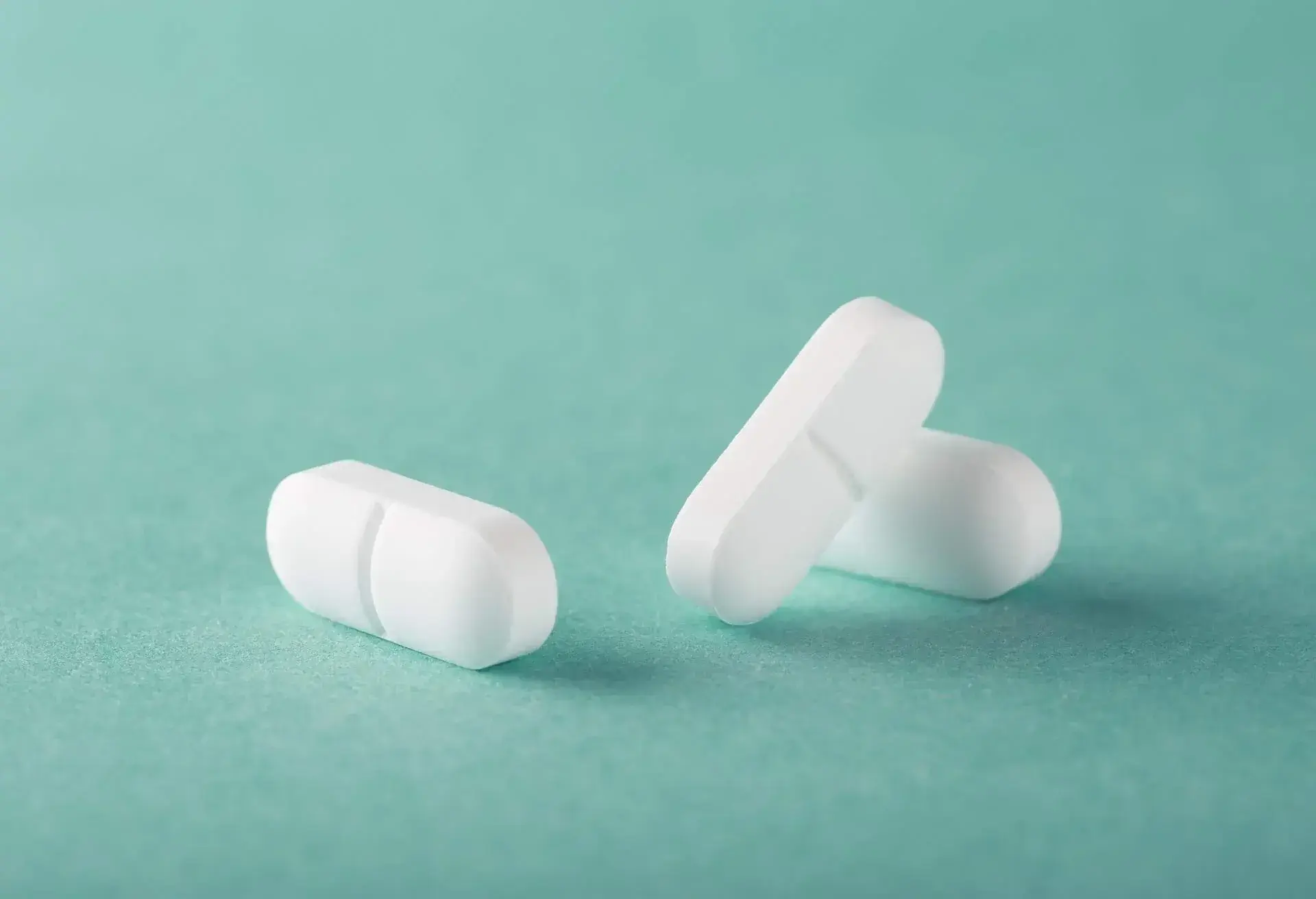 tablets are scattered on a green background