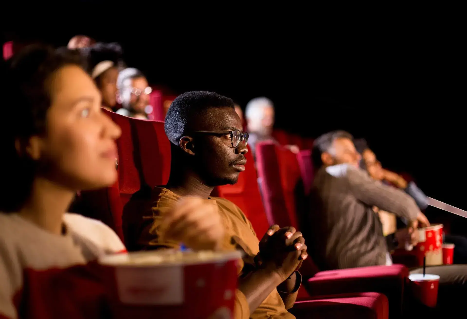 THEME_CINEMA_FILM_PEOPLE_EATING_POPCORN_GettyImages-1340577529