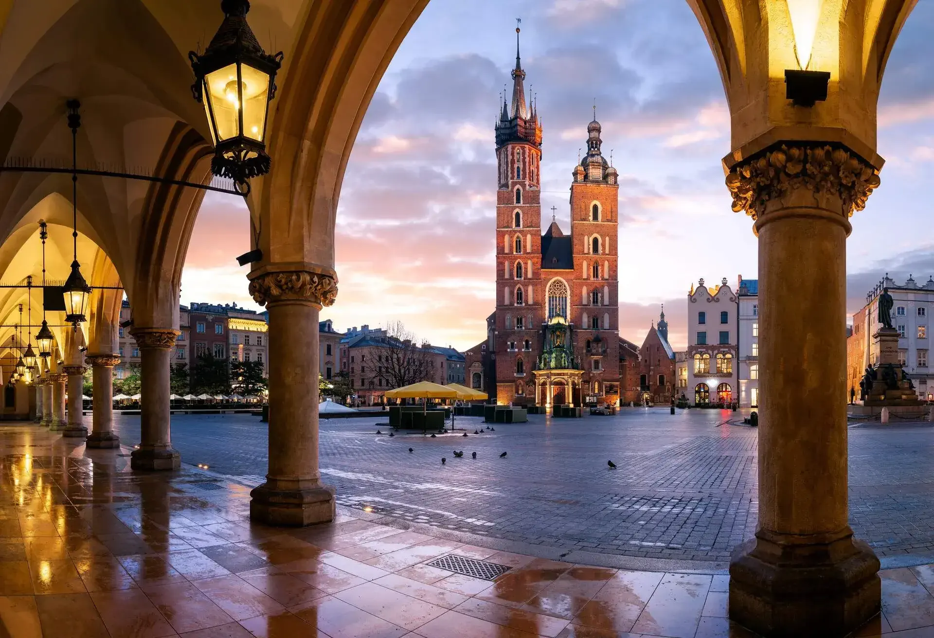 St Mary's Basilica, (Bazylika Mariacka) Church.Photograph taken at sunrise through the arches of the Cloth Hall, Krakow, Poland.