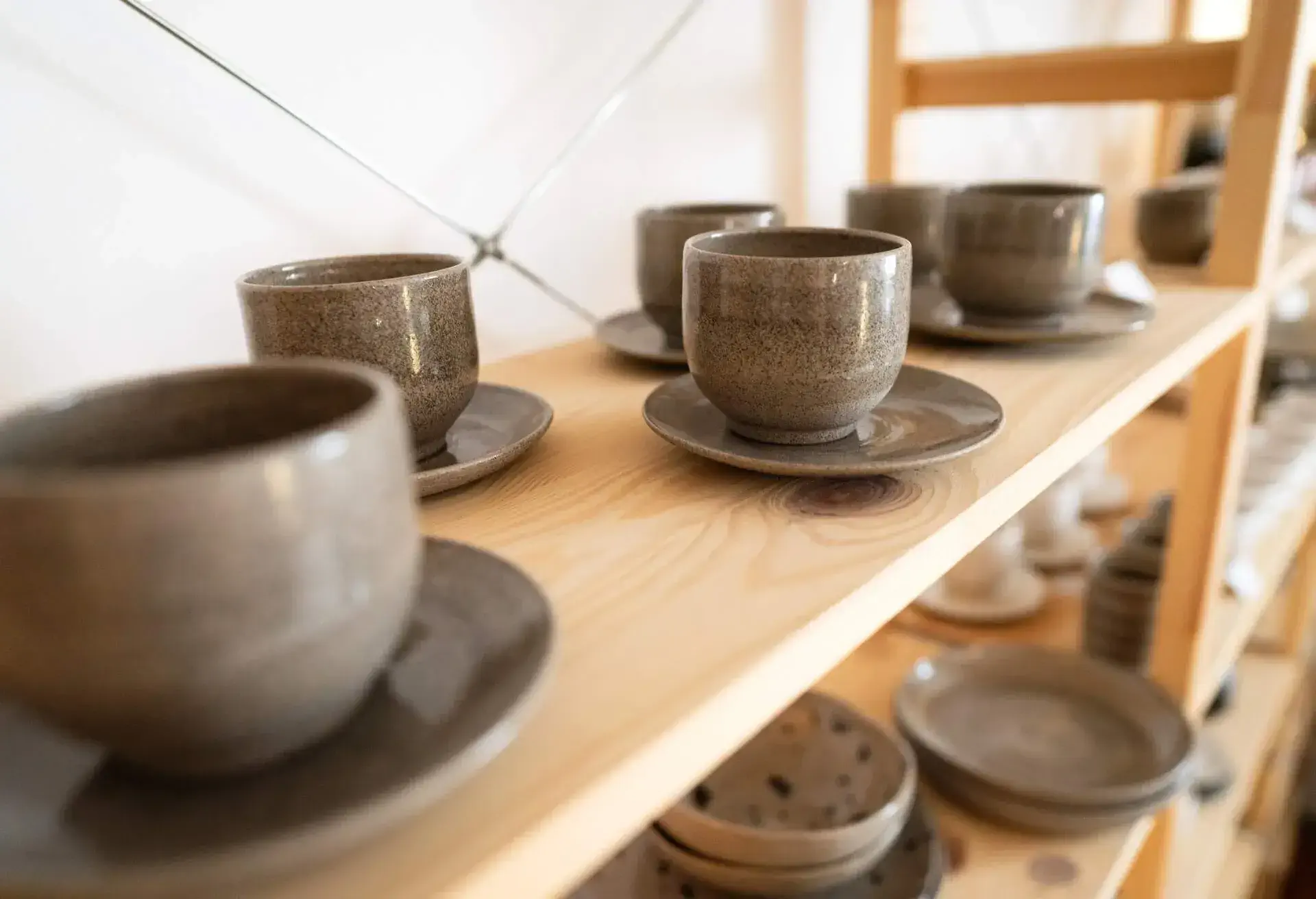 Shelf with ceramics in pottery workshop.