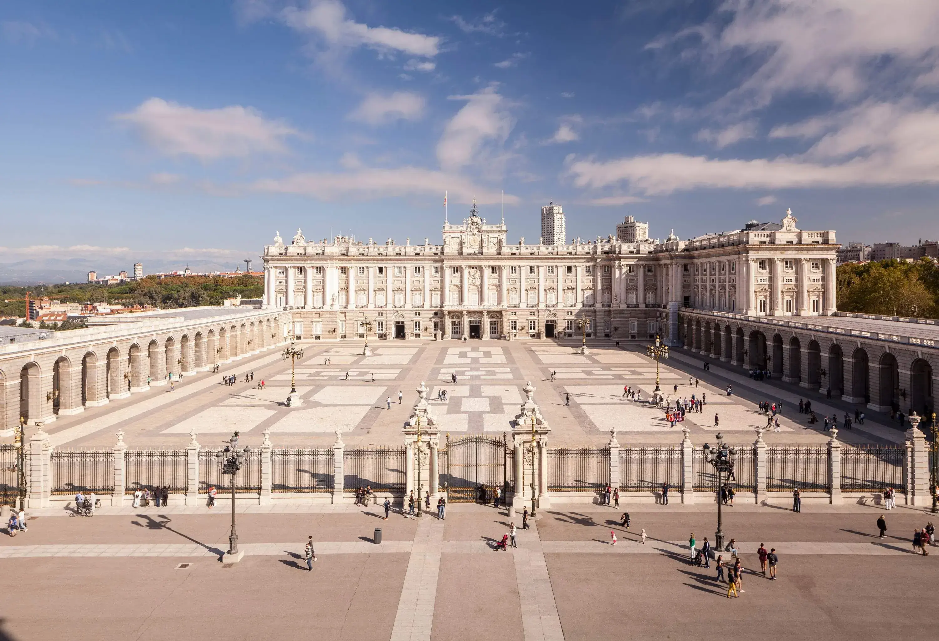 The facade of the Royal Palace of Madrid against the clear blue sky.