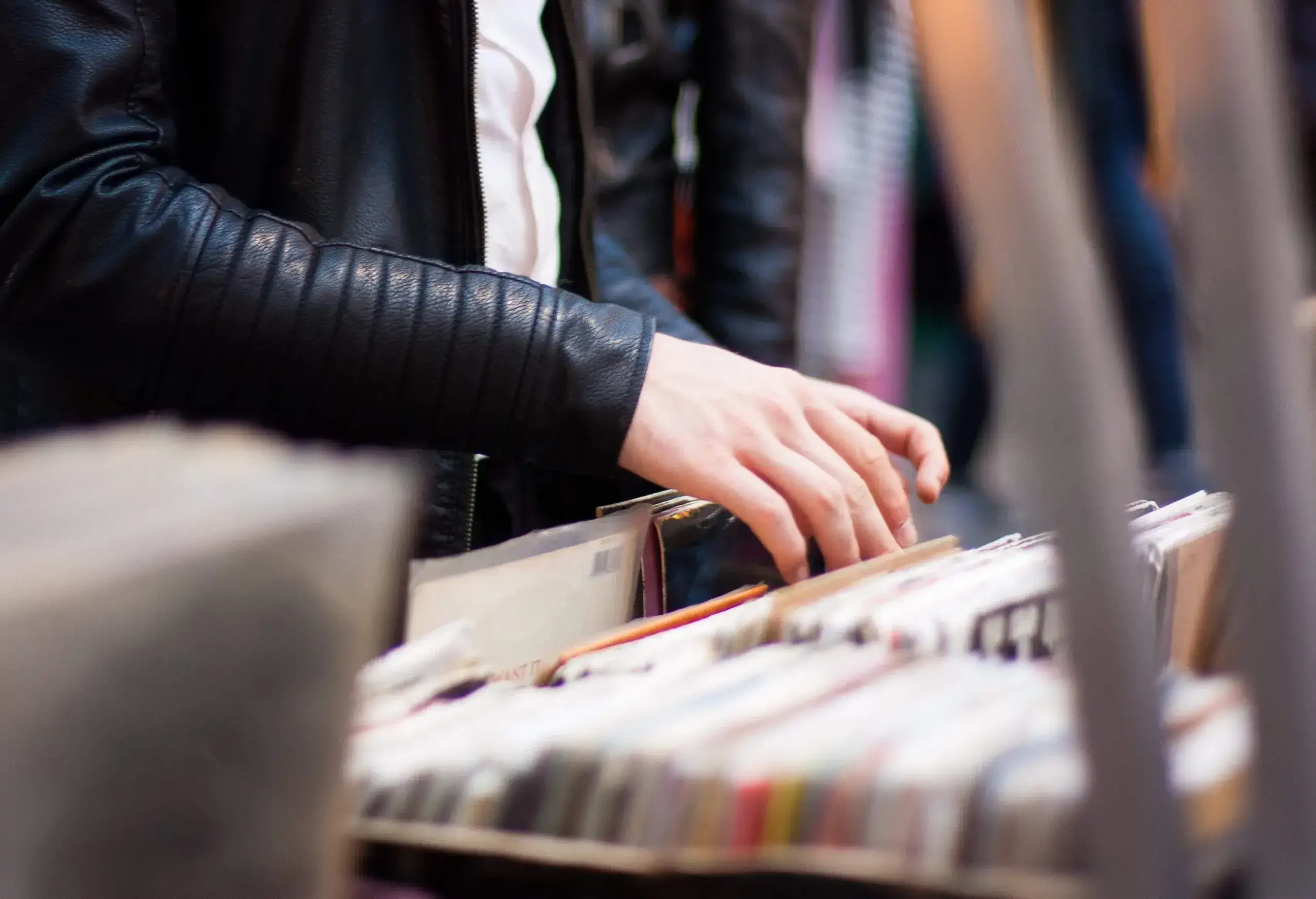 Young man choosing an LP at Spitalfields Markets, London.