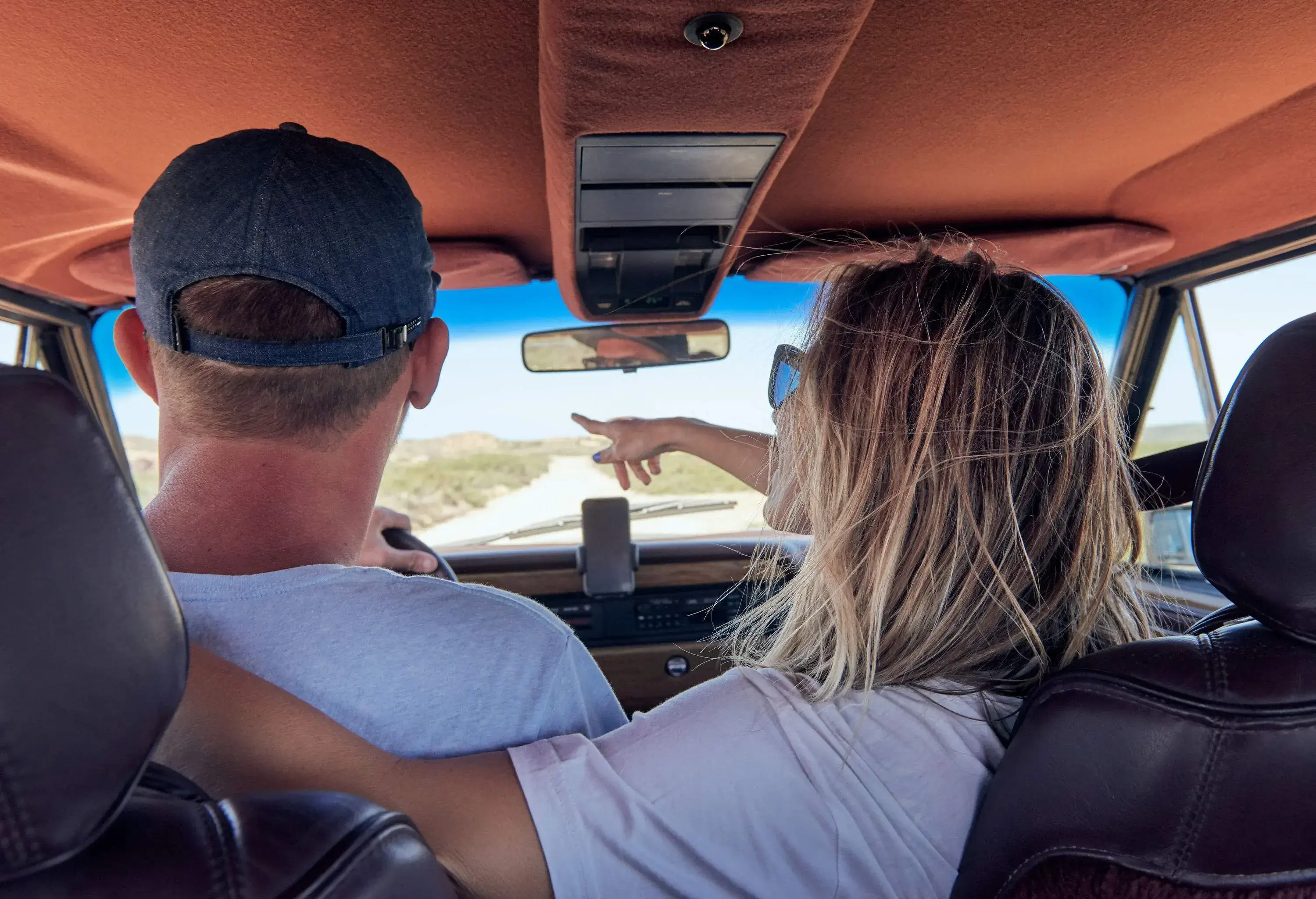 A couple enjoying each other's company inside a car shares a moment of togetherness while travelling.