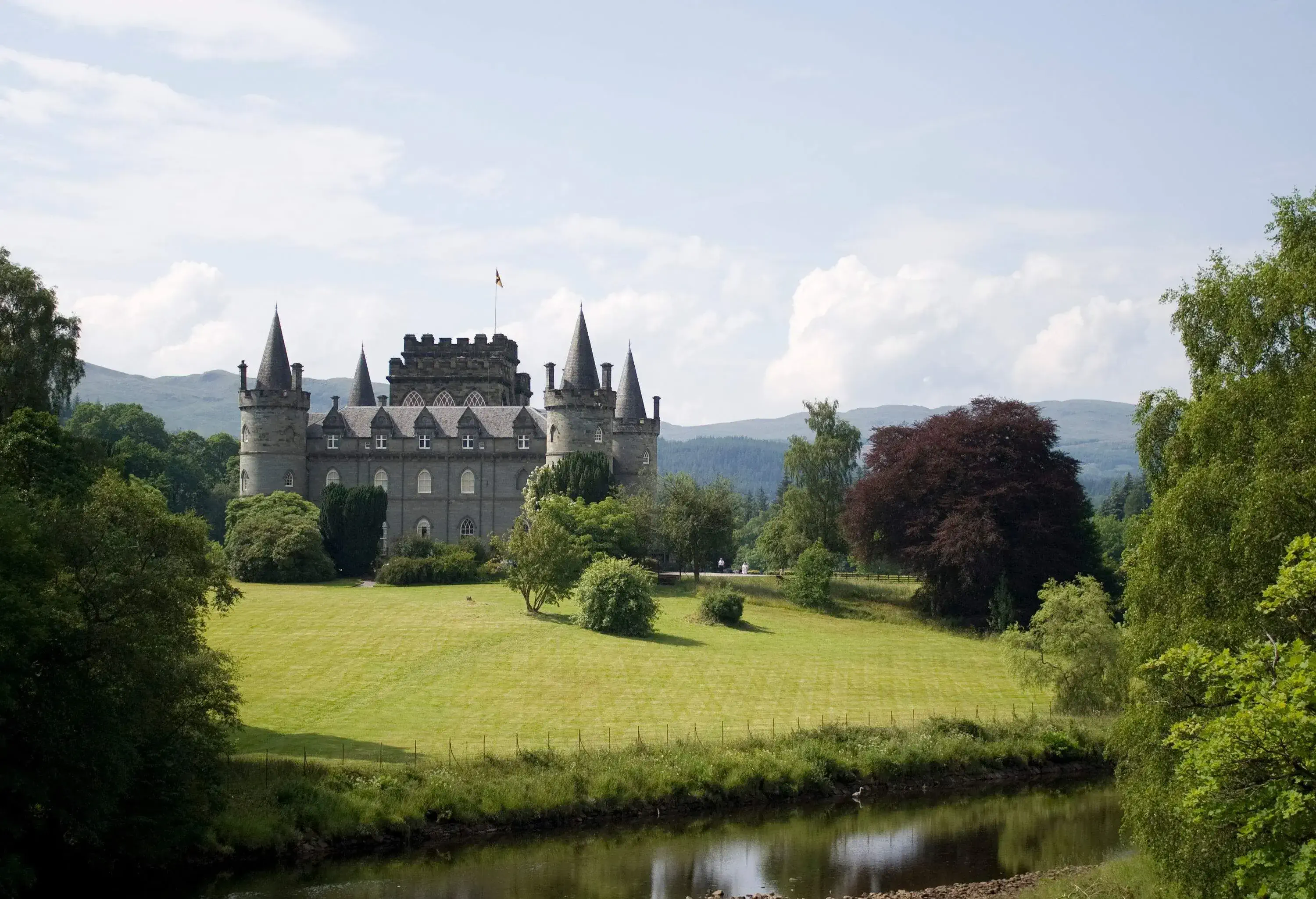 View of a well maintained castle by a river