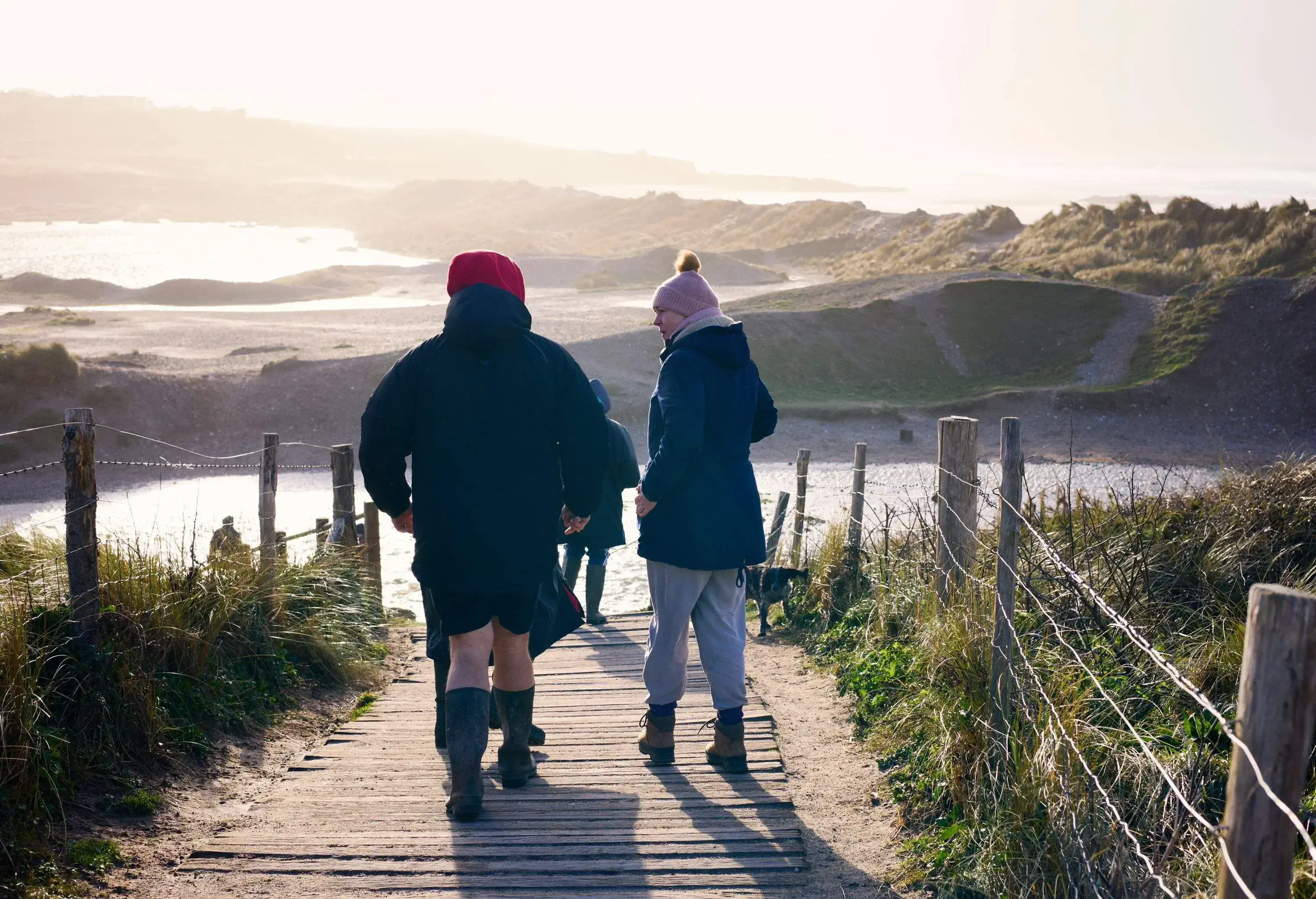 family walking towards a beach on New Year's Day