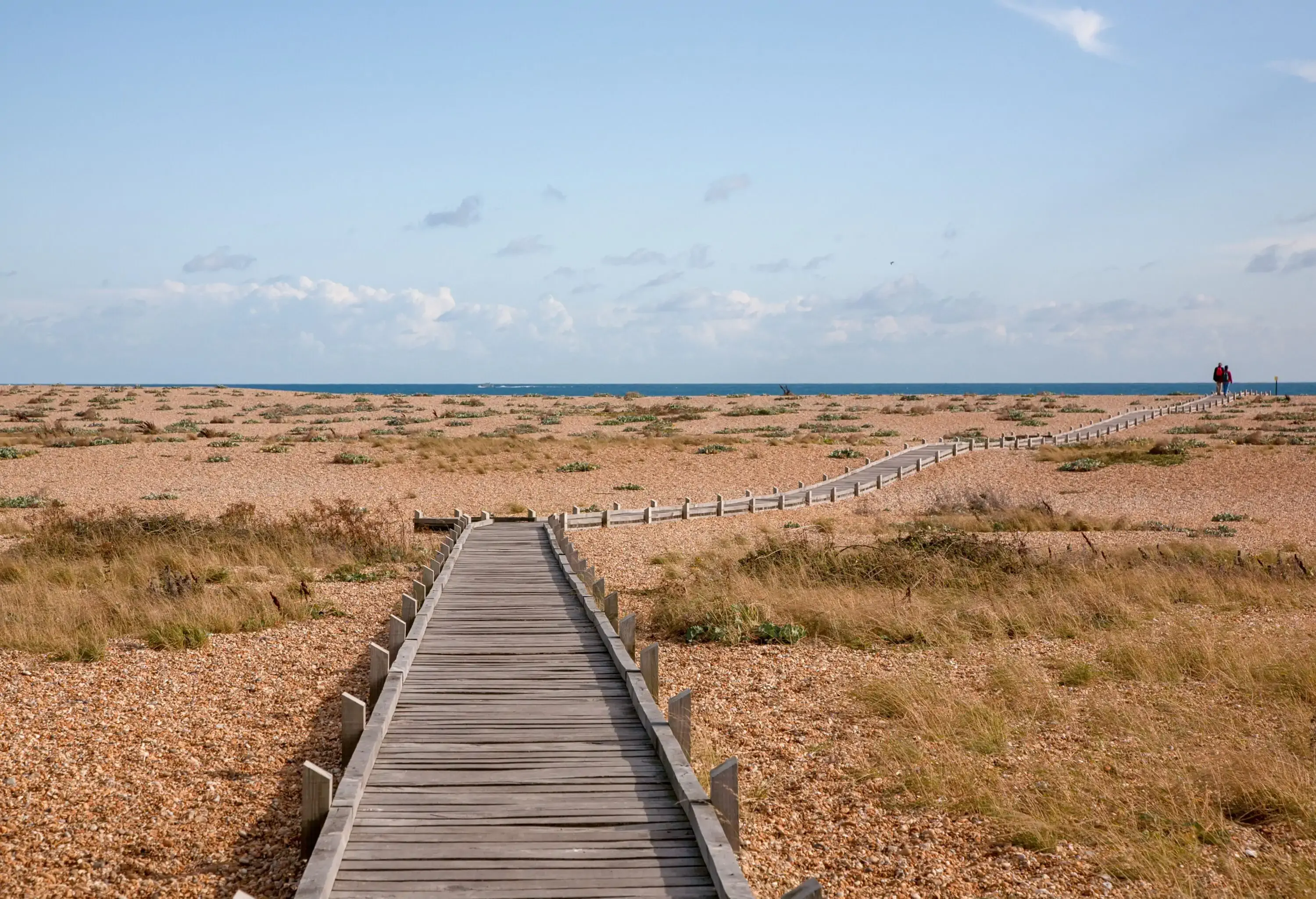 Wooden boardwalk on shingle beach at Dungeness, Kent