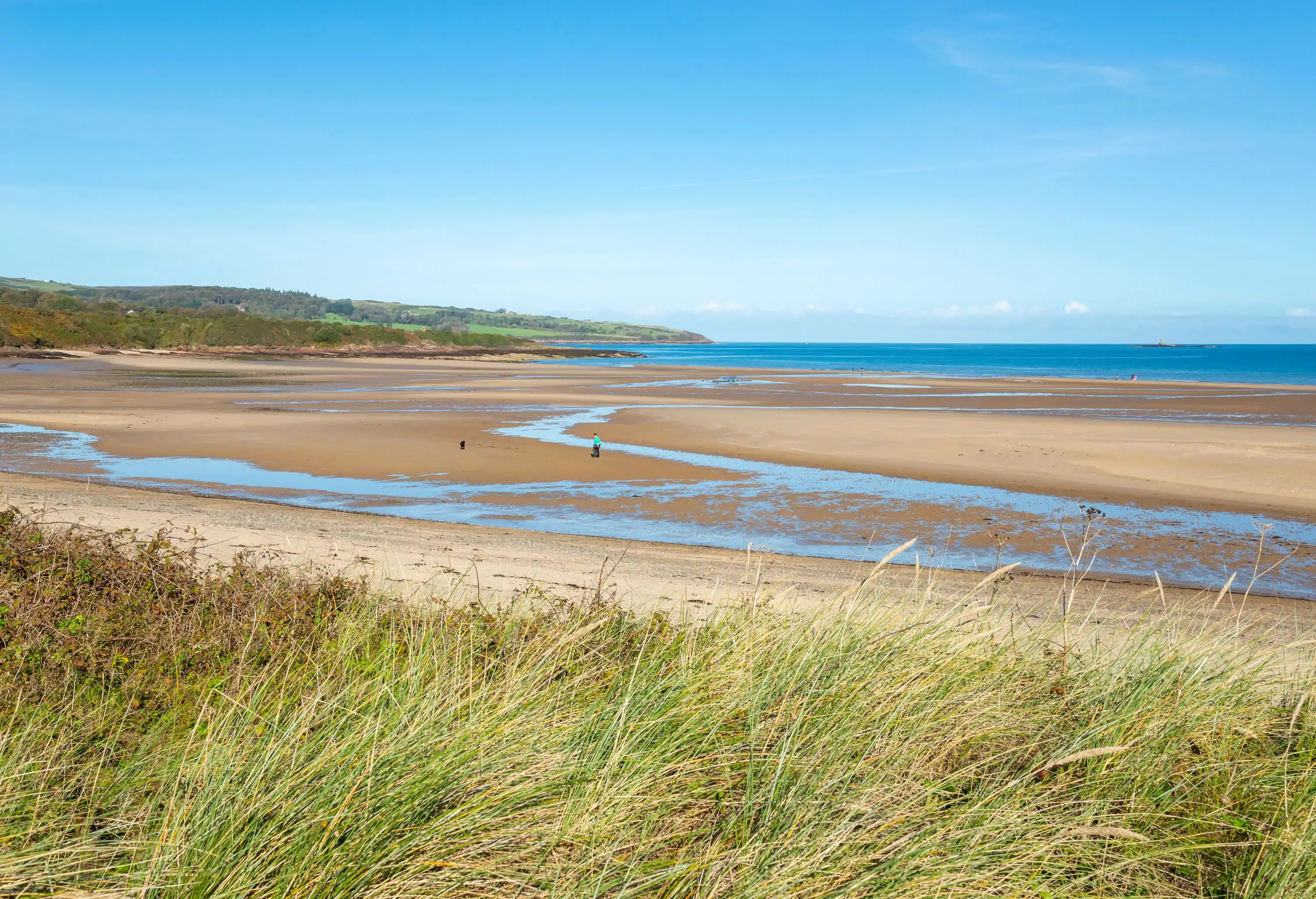 A sunny day at low tide on this beautiful beach on the east coast of Anglesey, north Wales.