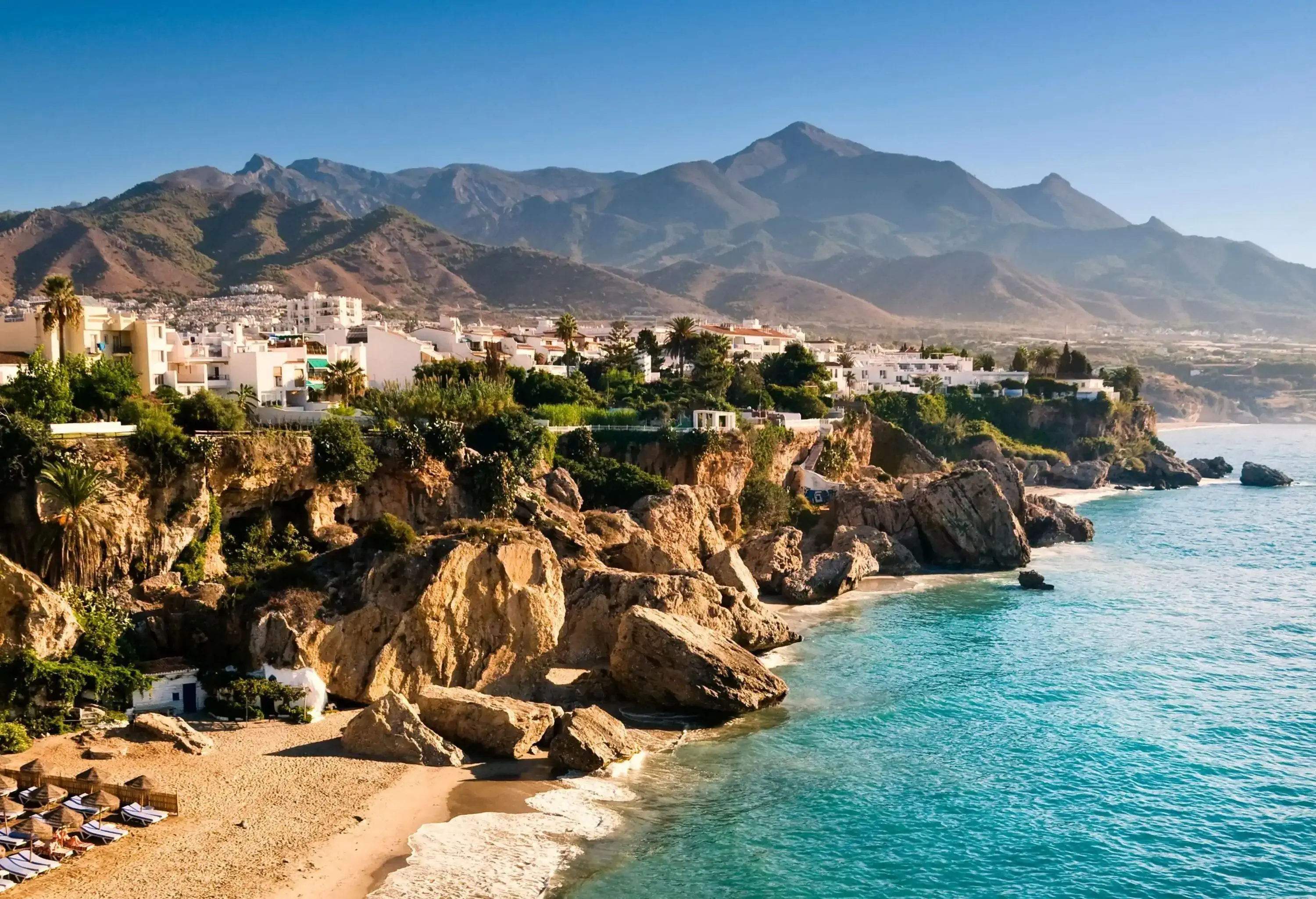 Aerial view of Nerja Beach in Andalucia at sunrise. Sierra Nevada in the background