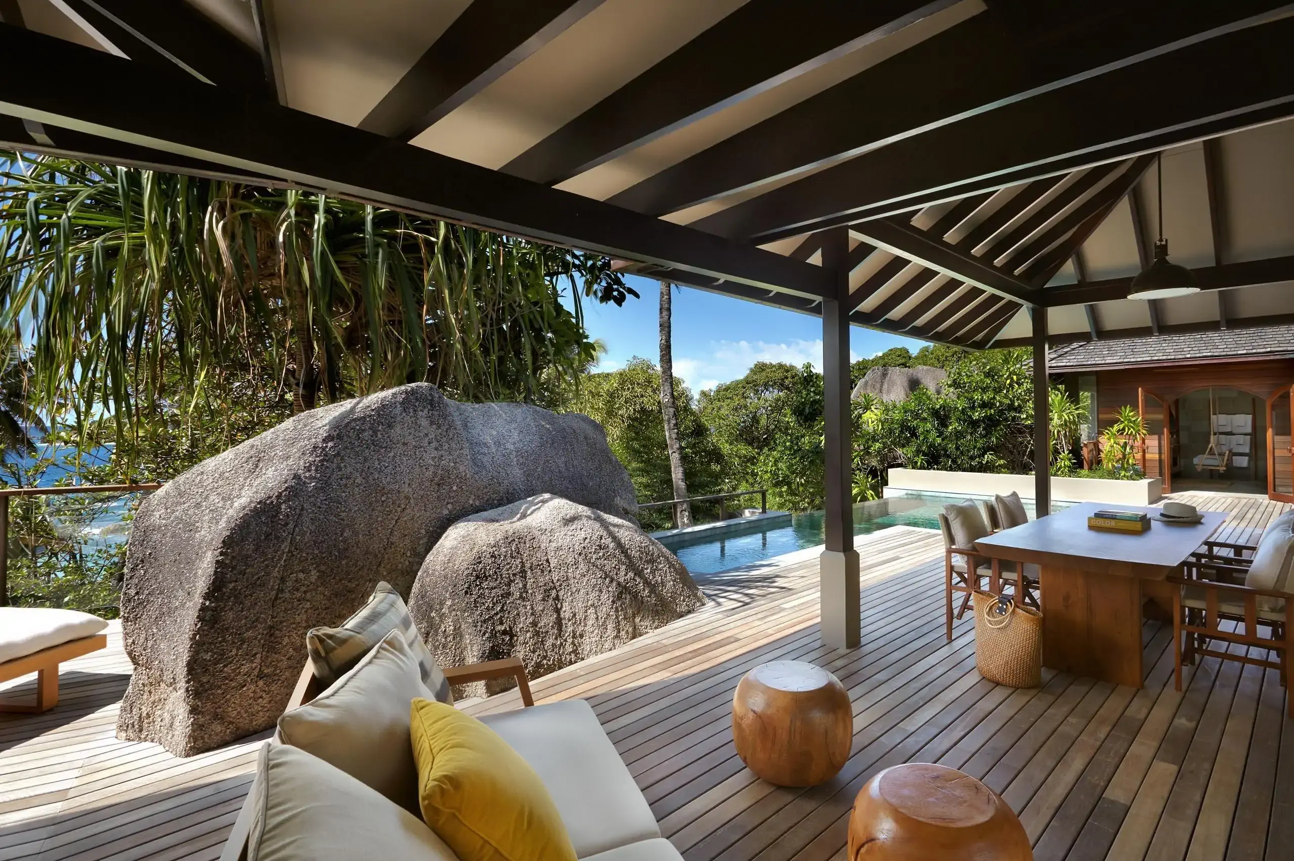 Wooden deck hotel patio built into boulders with private pool in a tropical setting