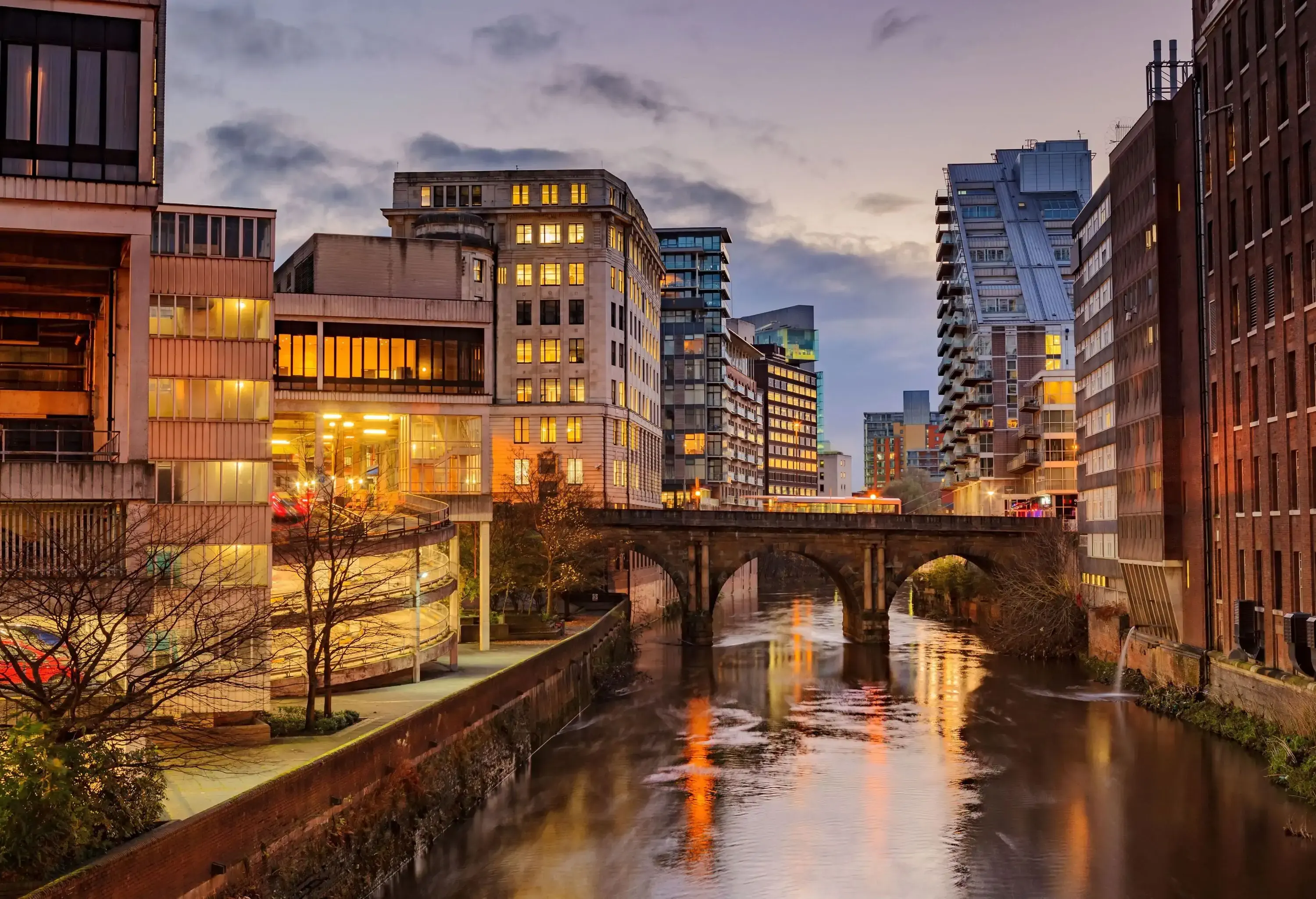 Modern apartments on both side of river Irwell passing through Manchester city center, UK.