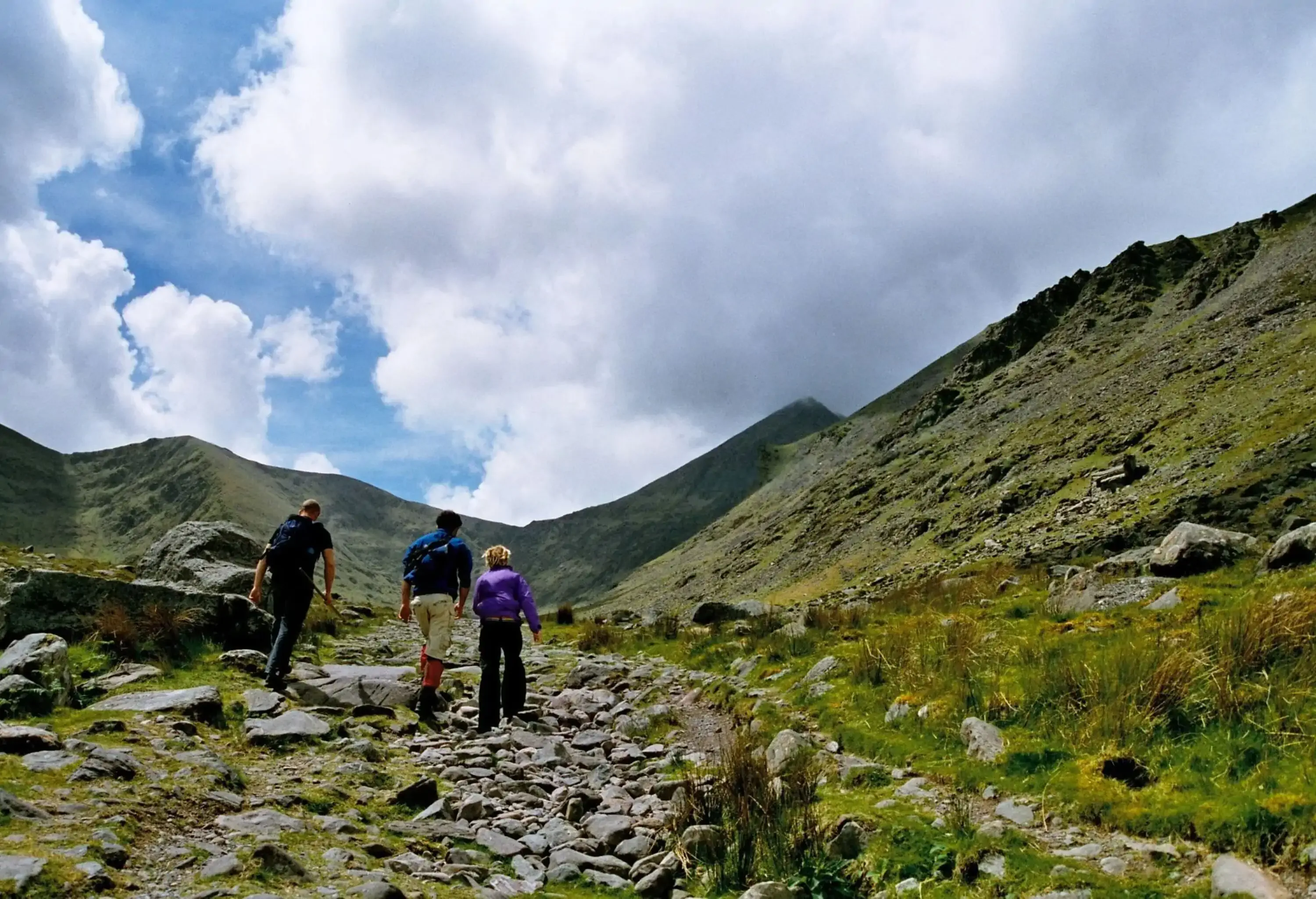 three people climbing the highest mountain in Ireland, Carrauntoohil in County Kerry