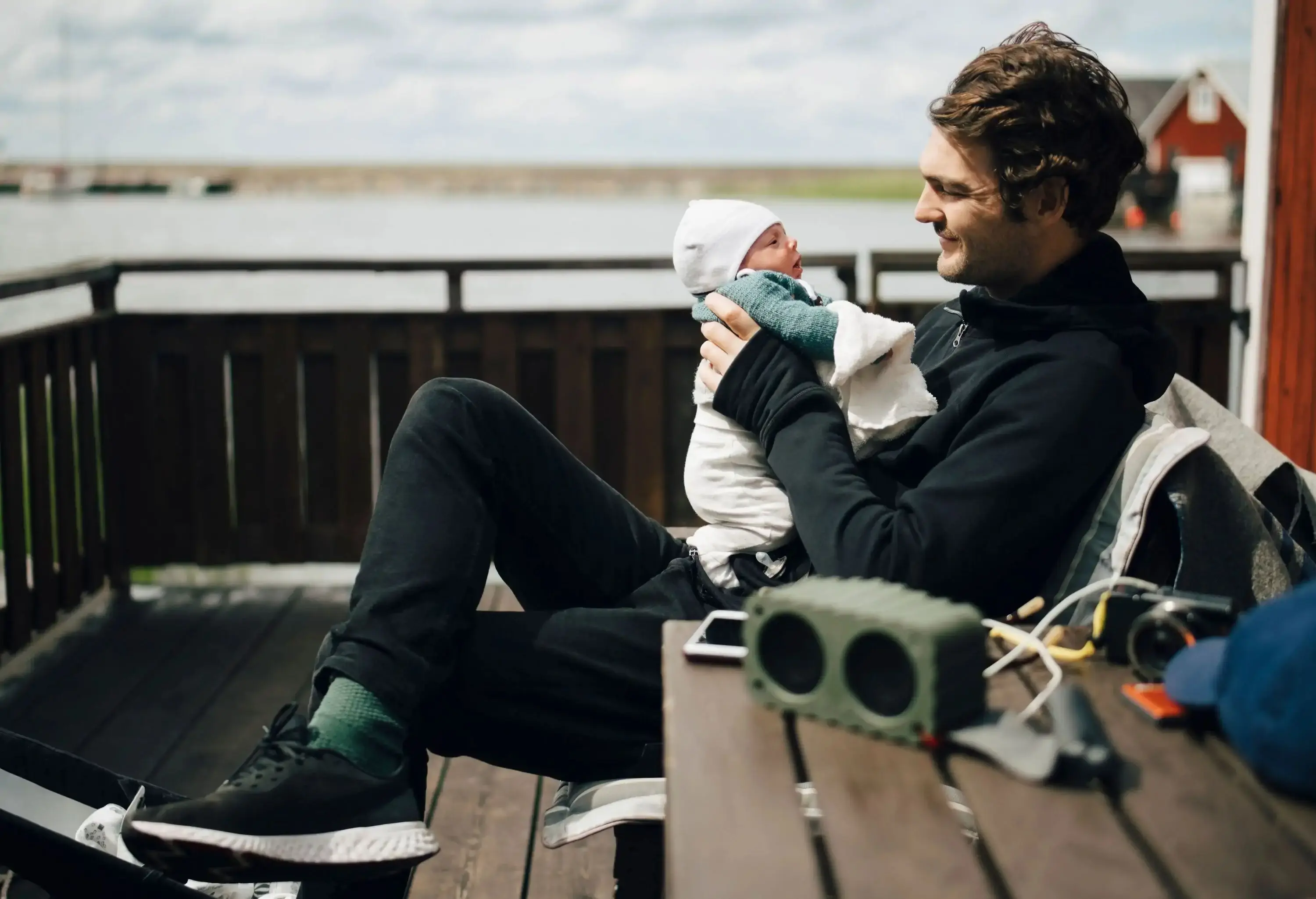 Father with newborn baby on holiday by the sea