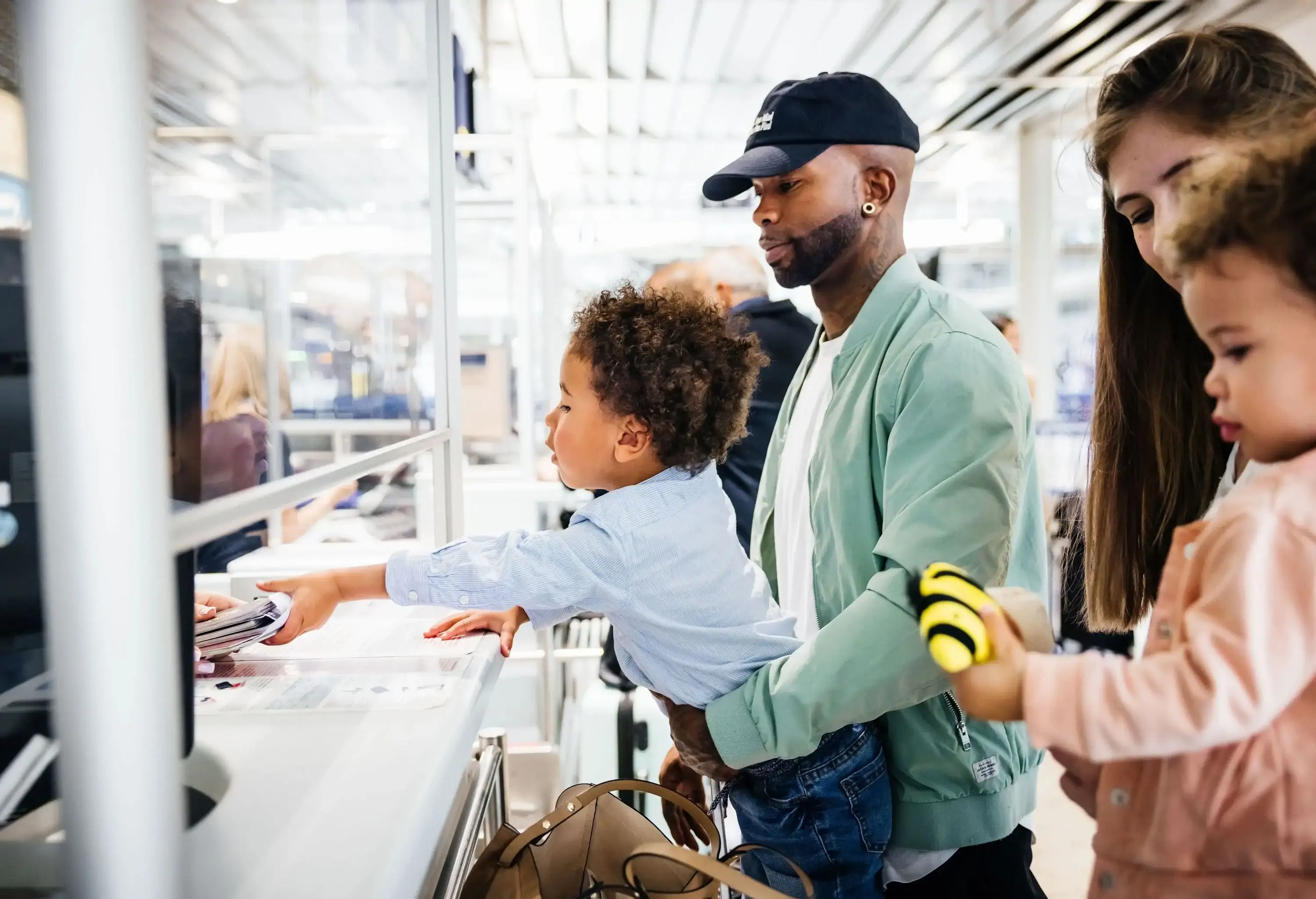Family of four at airport check-in counter